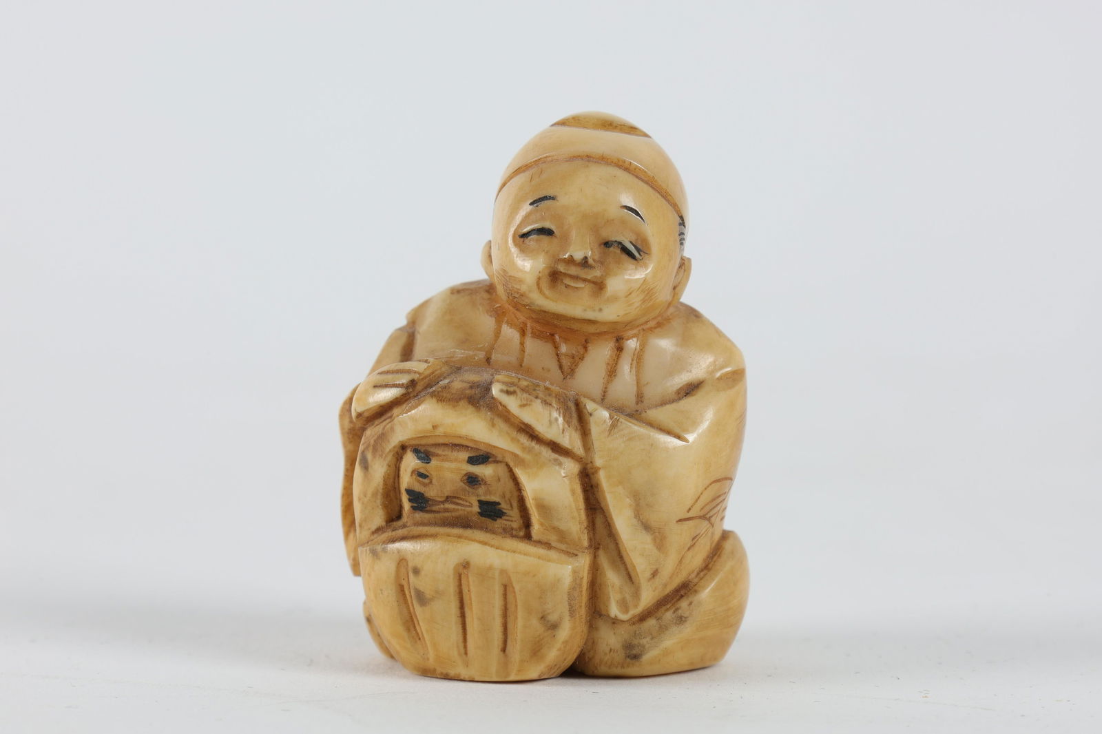 Carved Japanese Netsuke, Seated Boy with Basket (1 of 6)