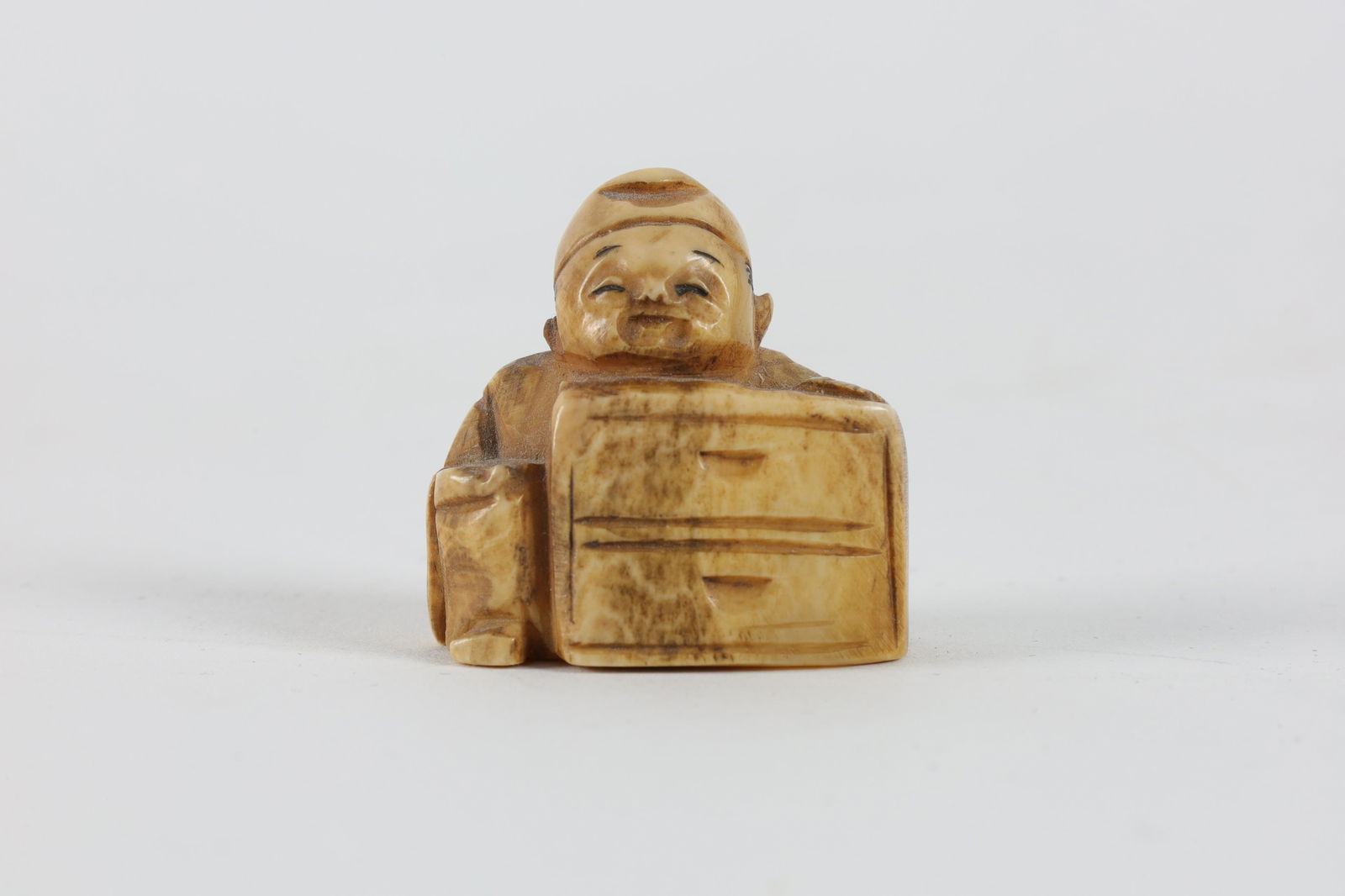 Carved Japanese Netsuke, Seated Figure with Chest (1 of 6)