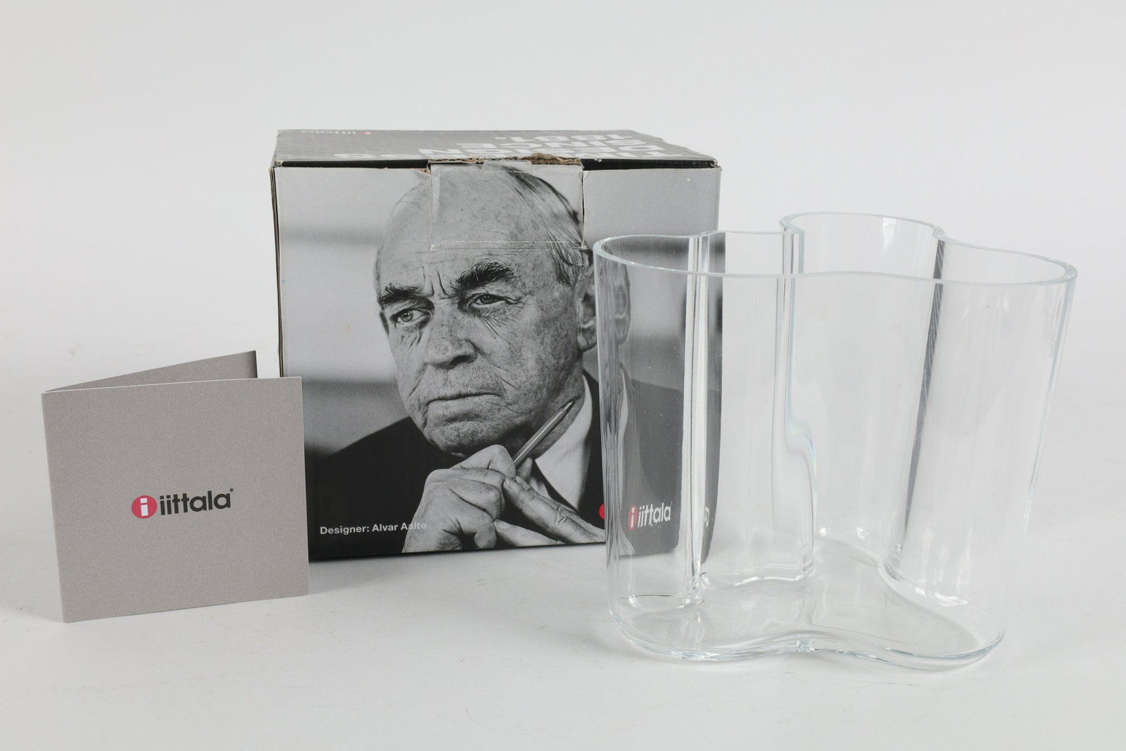 Alvar Aalto Iittala Finland Savoy Vase in Box: Small Alvar Aalto Iittala Finland Savoy Vase in Box. Stencil on base of vase. Measures 4 inches H x 4.5 W x 3.5 deep.