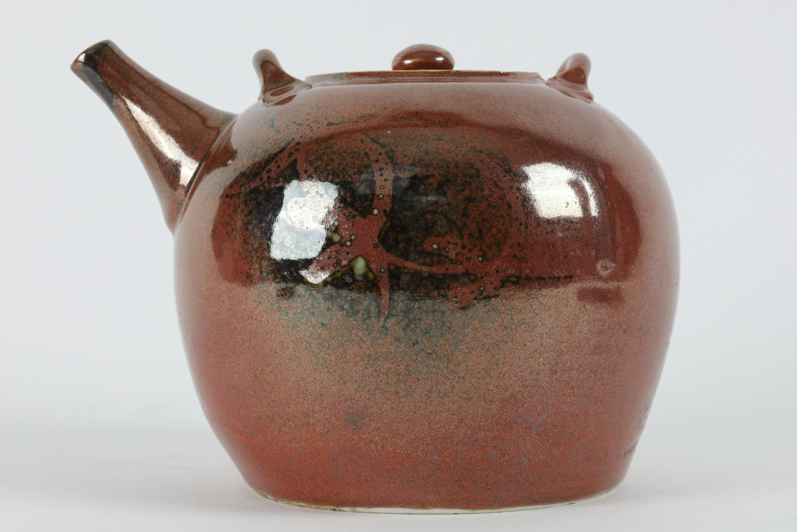 Chinese / Japanese Oxblood Sang De Boeuf Tea Pot: Chinese / Japanese Oxblood Sang De Boeuf Tea Pot. Signed on base. Measures 7 inches W x 5.5 H.