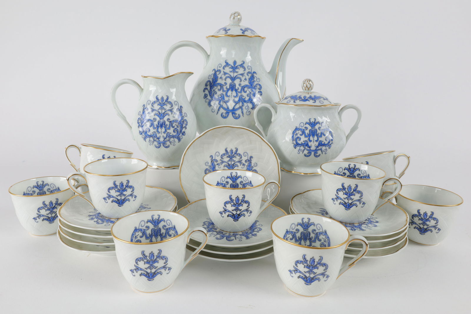 Bernardaud Limoges Louis XIII Tea Service for 11: L. Bernardaud et Cie Limoges Louis XIII Tea Service for 11. Tea pot, cream and sugar bowl and 11 teacups and saucers with blue decoration and basket pattern in the porcelain.