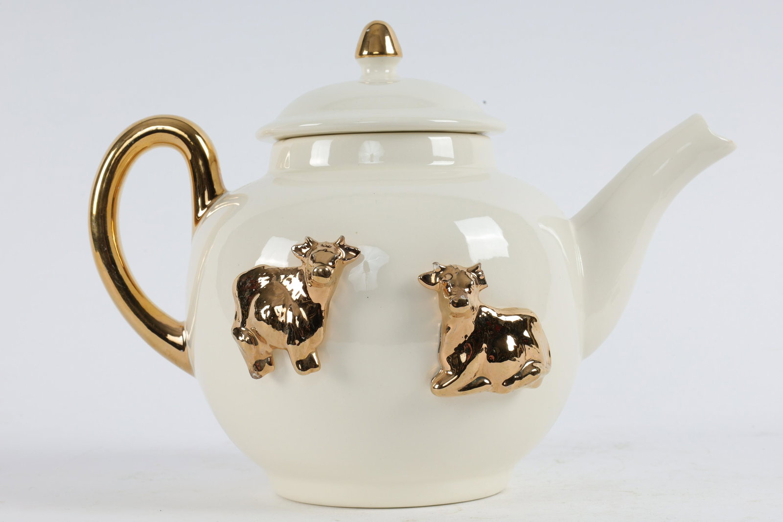 Vintage Cream and Gold Teapot, Applied Golden Cows: Vintage Cream and Gold Teapot, Applied Golden Cows. Measures 9.5 inches L x 5.5 W x 7 H.