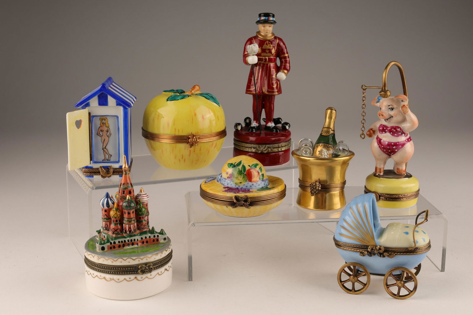 Collection Limoges Peint a Main Figural Pill Boxes: Collection of 8 Limoges Peint a la Main Figural Pill Boxes. Apple box measures 2.5 inches diameter and marked Artoria No. 21, Moscow St Basil's measures 4 inches H, Nudie beach house measures 3 inches