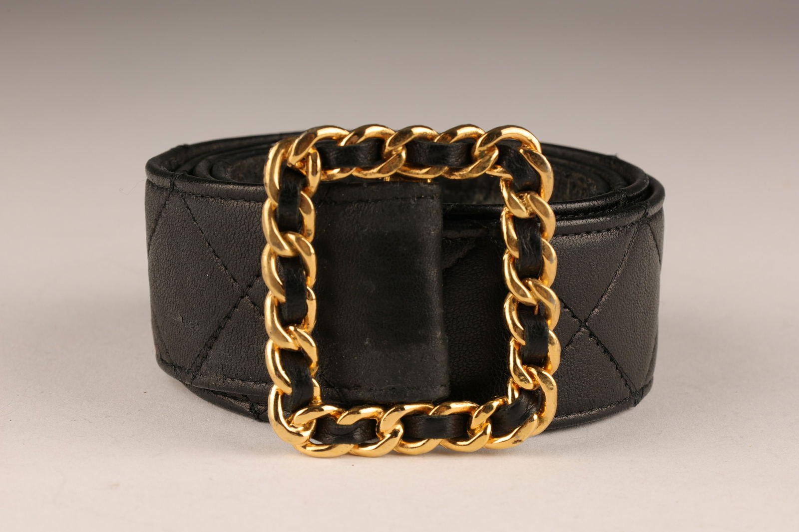 Vintage Chanel Quilted Black Leather Belt: Vintage Chanel Quilted Black Leather Belt with Gold Tone Chain Buckle. 37 inches L, marked on back.