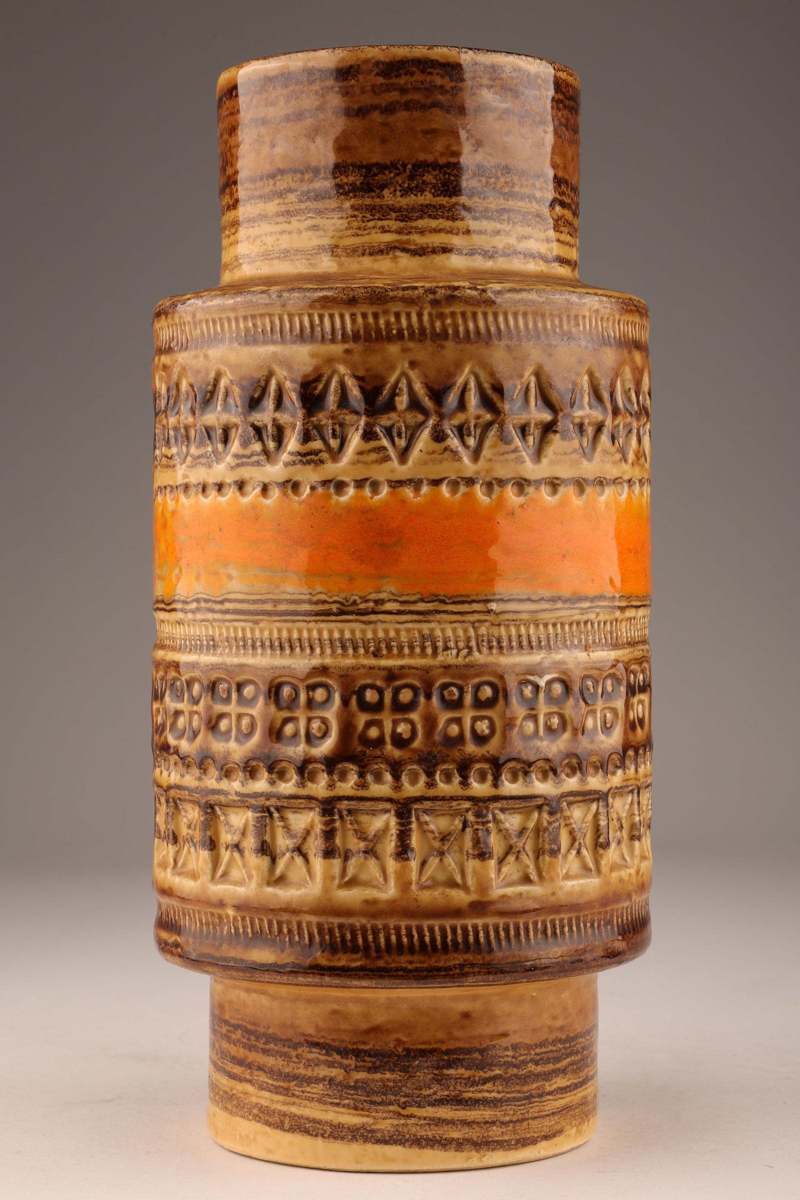 Mid Century Modern Italian Bitossi Vase: Mid Century Modern Italian Bitossi Vase with impressed geometric designs in orange and brown glaze. 10 inches H x 4.5 W.