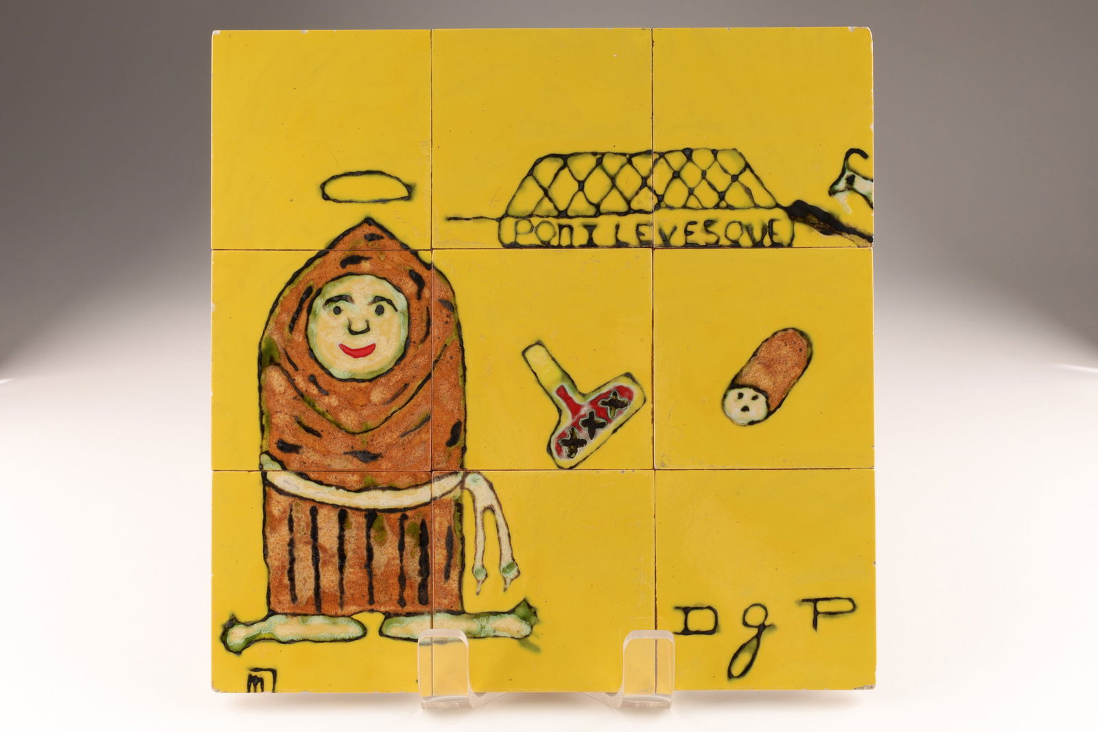 Quebec Modernist 1960s Art Pottery Tile Hot Plate: Quebec modernist art pottery tiles set as hot plate or trivet, hand painted with stylised monk figure, the Pont Levesque and various other items. With initials on lower right side DGP. 12 x 12 inches.