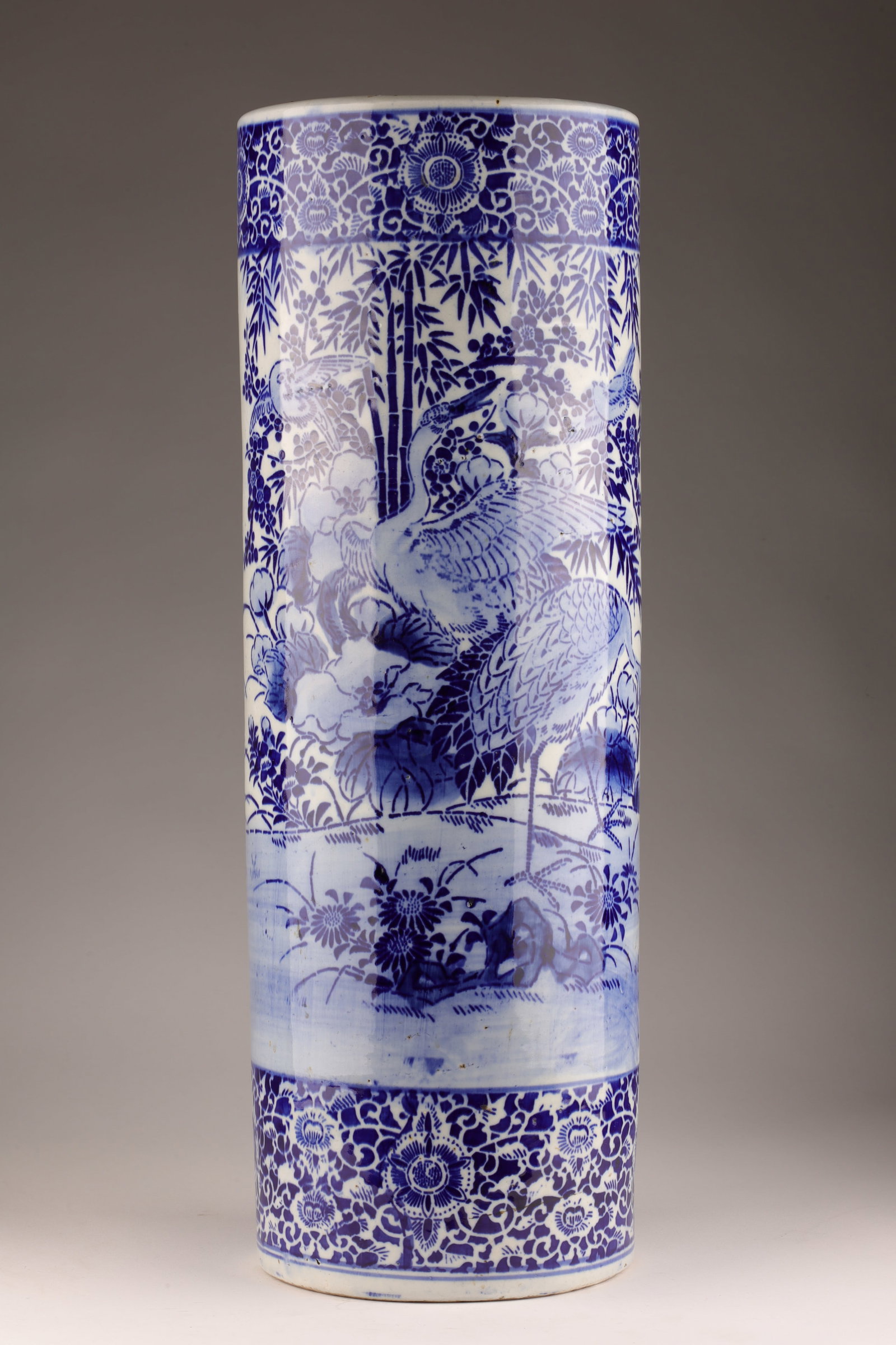 Antique Chinese Blue / White Umbrella Stick Stand: Antique Chinese Blue and White Umbrella Stick Stand decorated with birds and flowers. Base has been restored. 24 inches h x 8.25 diameter.