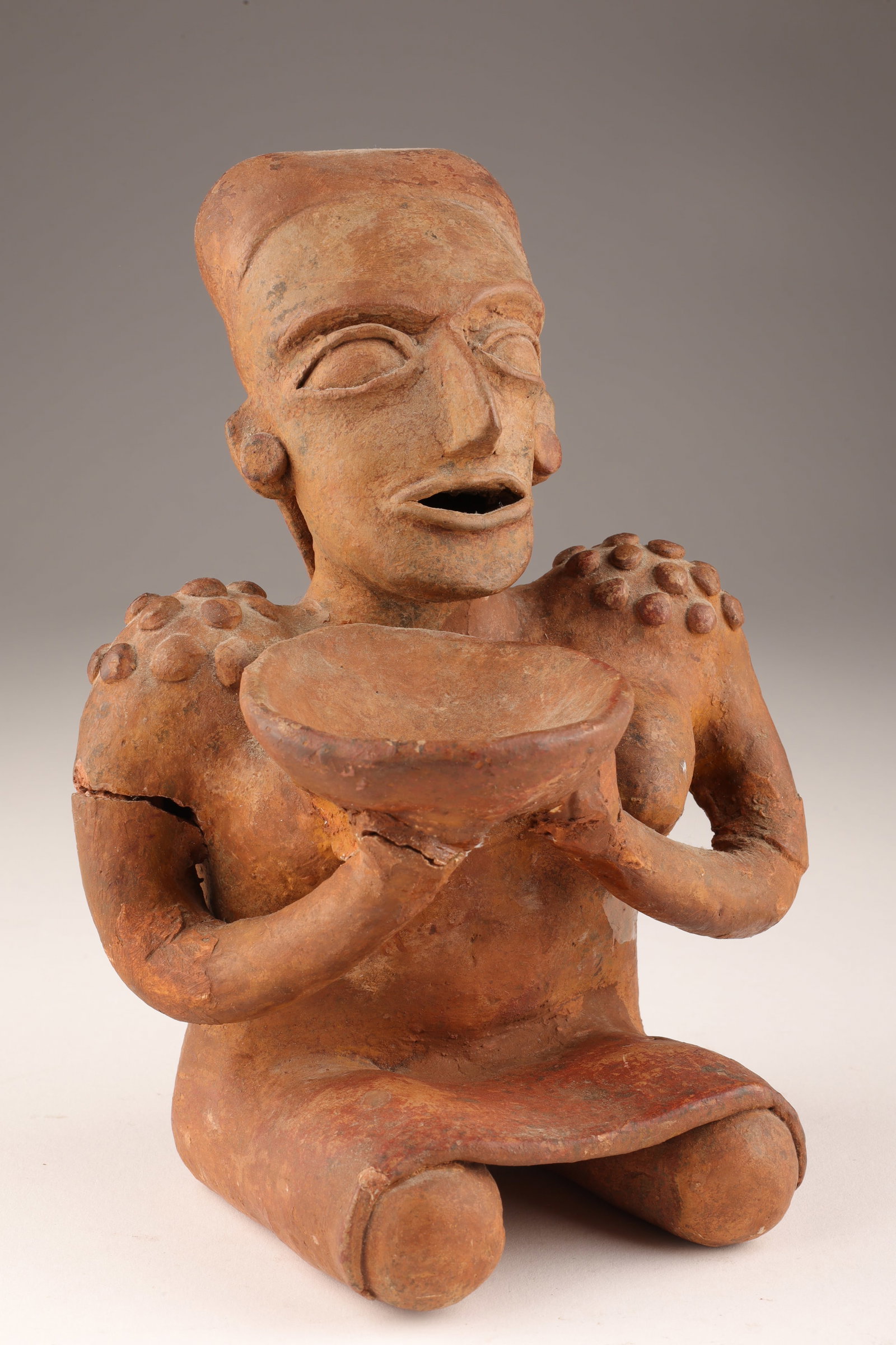 Antique Terracotta Mexico Jalisco Seated Figure: Antique Terracotta Mexico Jalisco Seated Figure with Offering Bowl. Restoration to arms, please see photos. 8 inche sH x 5.5 W x 4 deep.