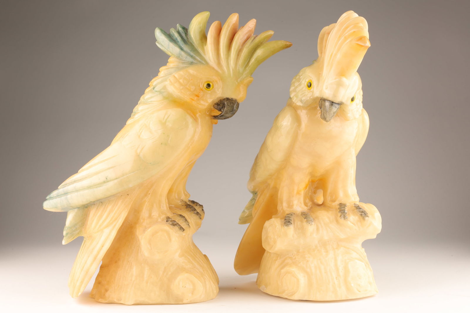Pair Art Deco Italian Tinted Alabaster Cockatoos: Pair Art Deco Italian Tinted Alabaster Cockatoos. 13 inches H x 12 W.