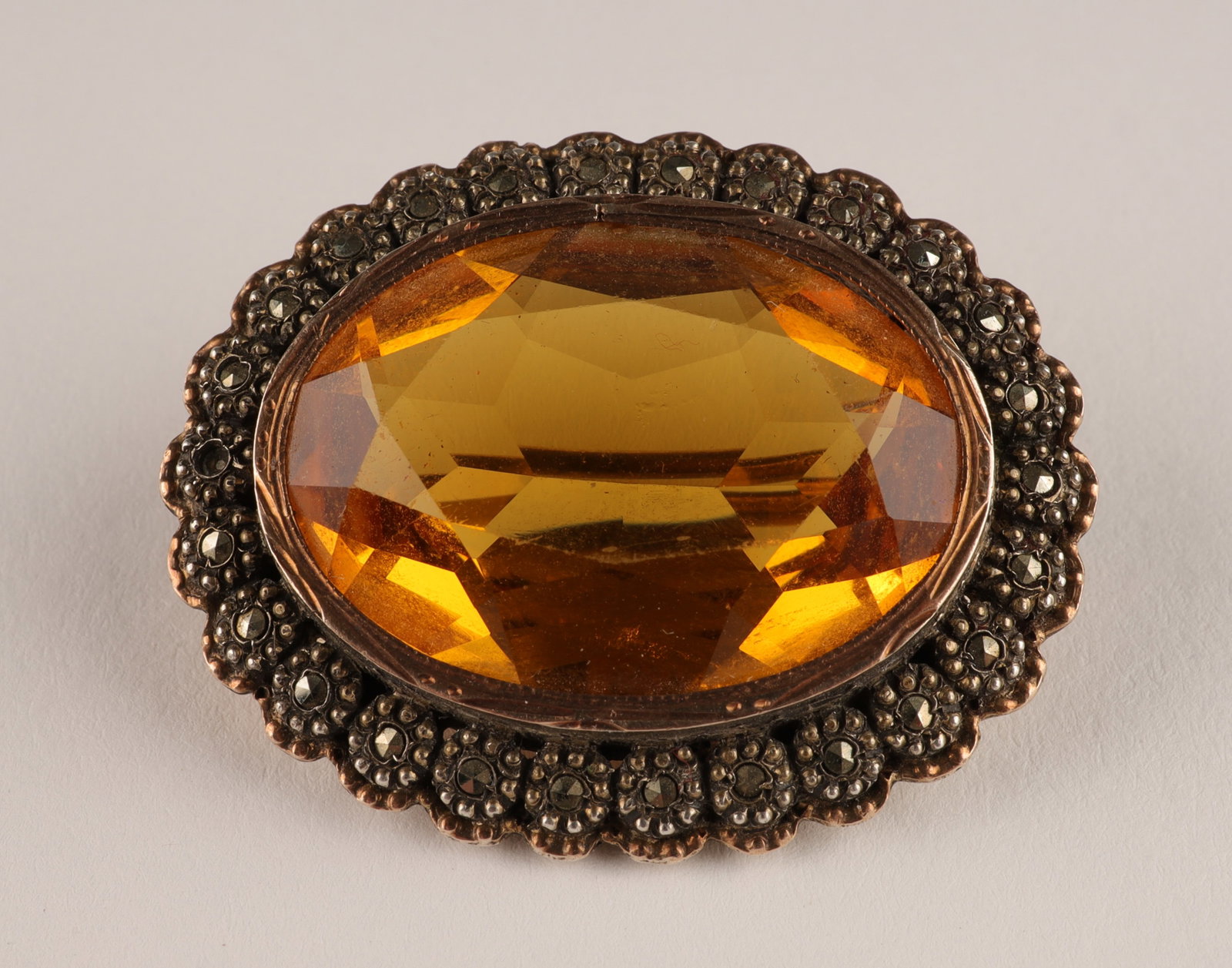 French Silver, Marcasite and Citrine Glass Brooch: French Silver, Marcasite and Faceted Citrine Glass Brooch. Hallmarked on verso. 1.5 inches x 1 W.