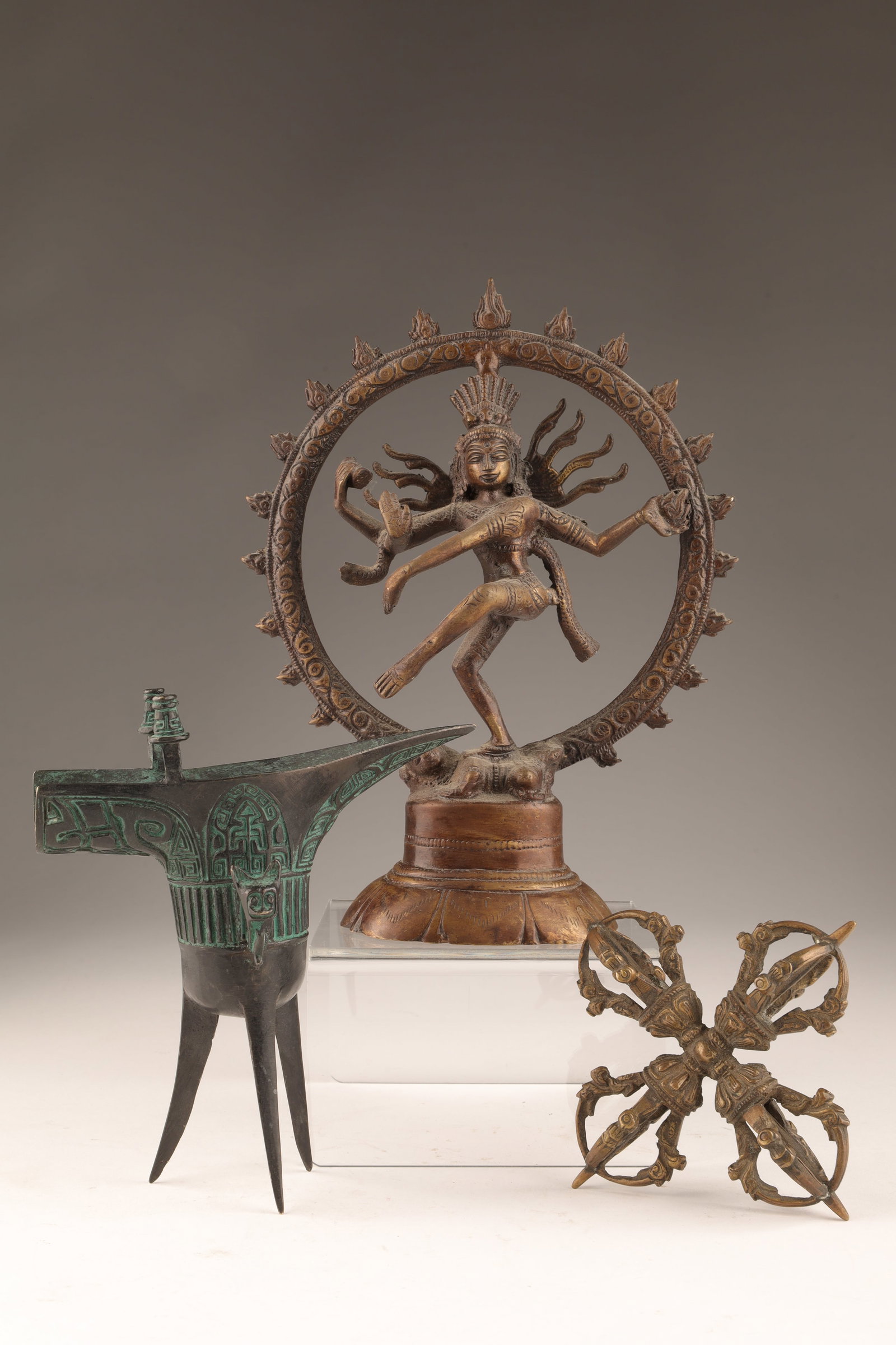 Collection Asian Bronze Items, Tibet, India, China: Collection Asian Bronze Items, Tibet, India, China. Indian dancing Shiva Nataraja (8 inches H), Tibetan ritual Dorje Scepter (4 inches W), Chinese Wine Cup (5.25 inches H x 5W).