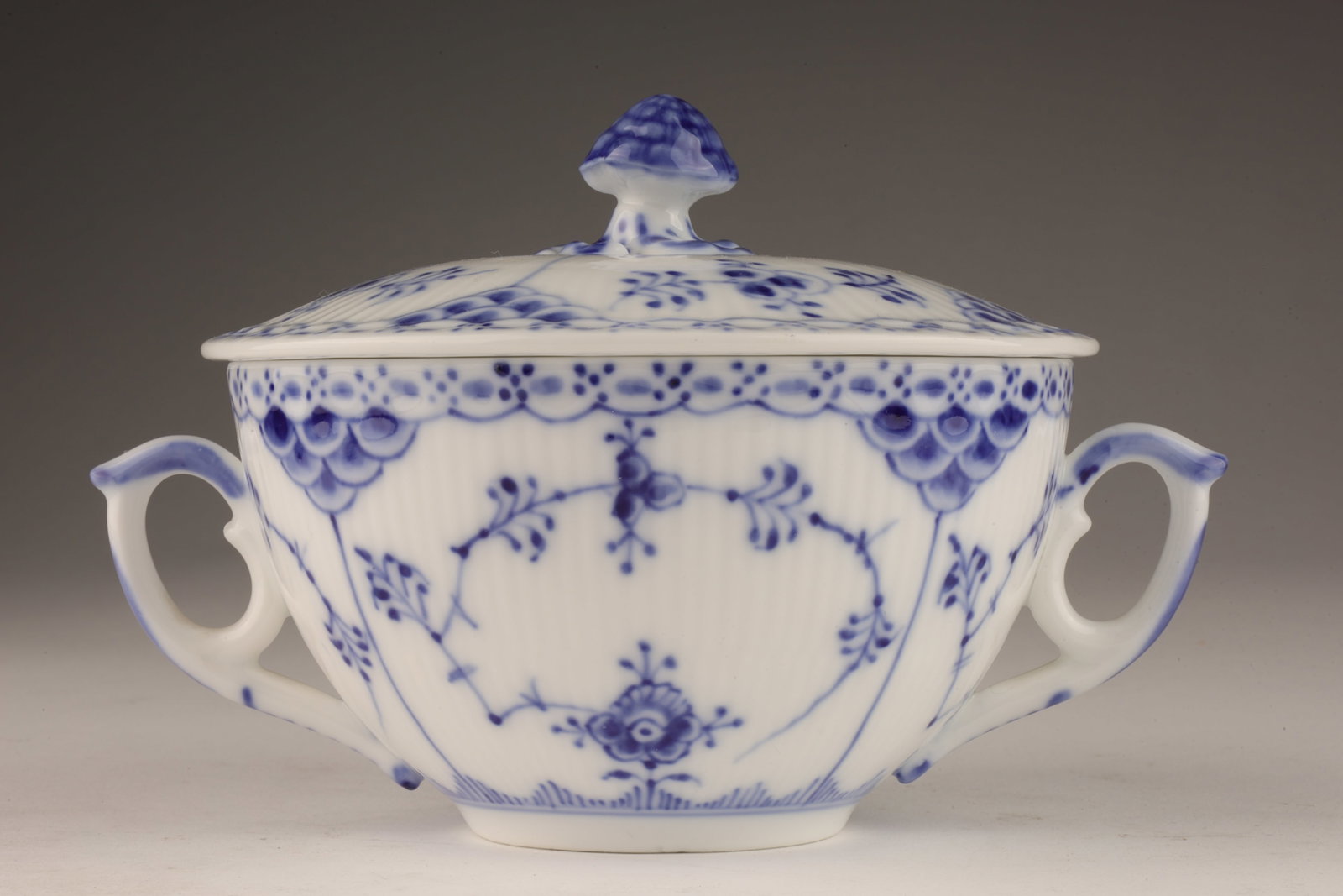 Royal Copenhagen Blue Half Lace Broth Cup: Rare Royal Copenhagen Denmark blue fluted half lace white porcelain lidded bouillon cup or dish with decorative floral handle, both pieces fully marked and also marked 1/764 . 6 inches W including han