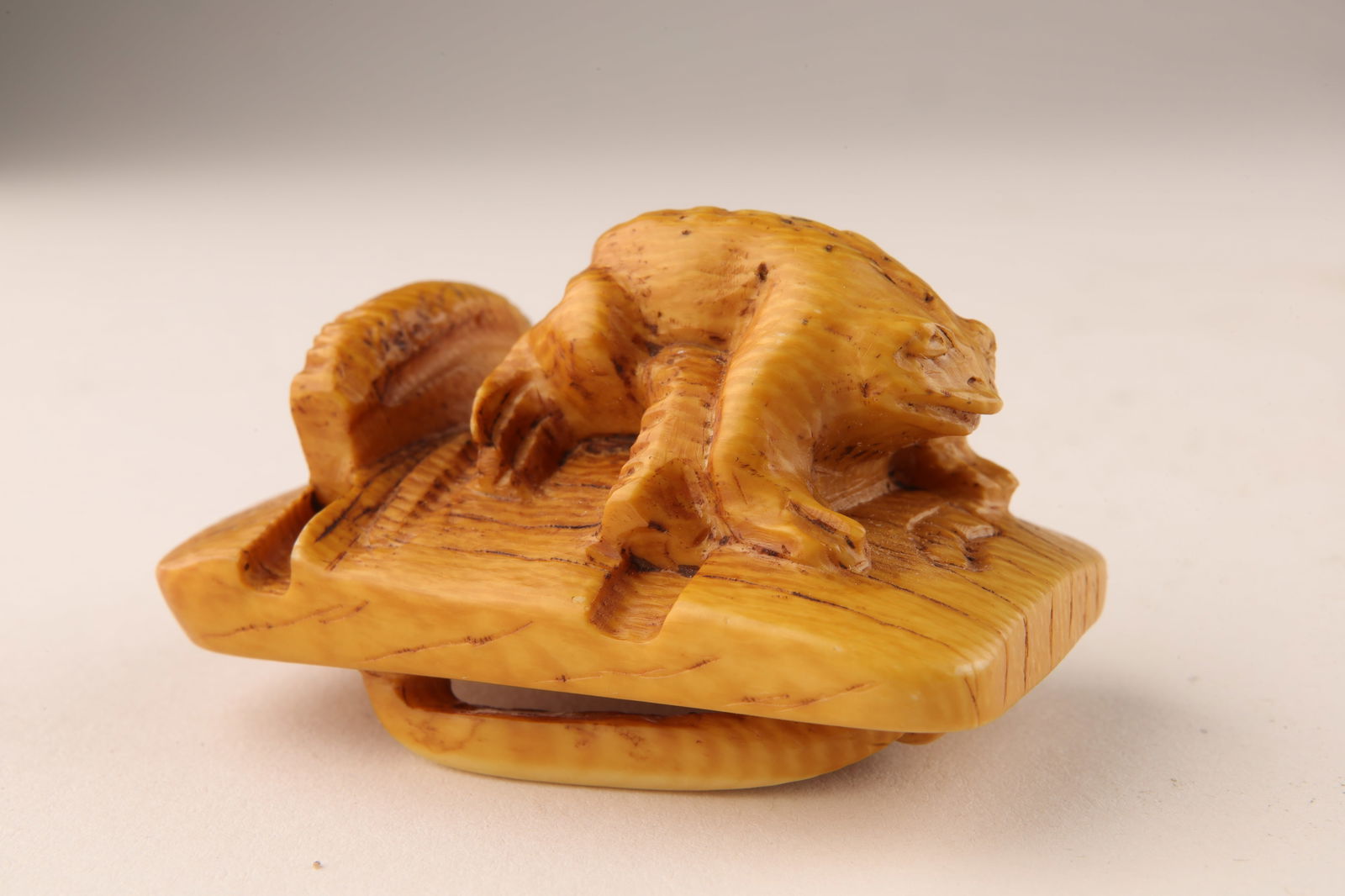 Signed Japanese Carved Netsuke Toad on Sandal: Signed Japanese Carved Netsuke Toad on Sandal. 2 inches L x 1.25 H x 1.25 W. This item cannot be exported from Canada.