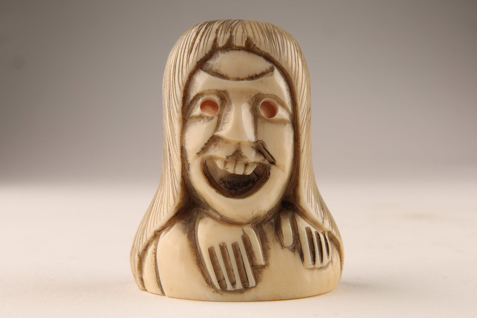 Signed Japanese Carved Netsuke Bust of Woman: Signed Japanese Carved Netsuke Bust of a Woman with Long Hair. 1.5 inches H. This item cannot be exported from Canada.