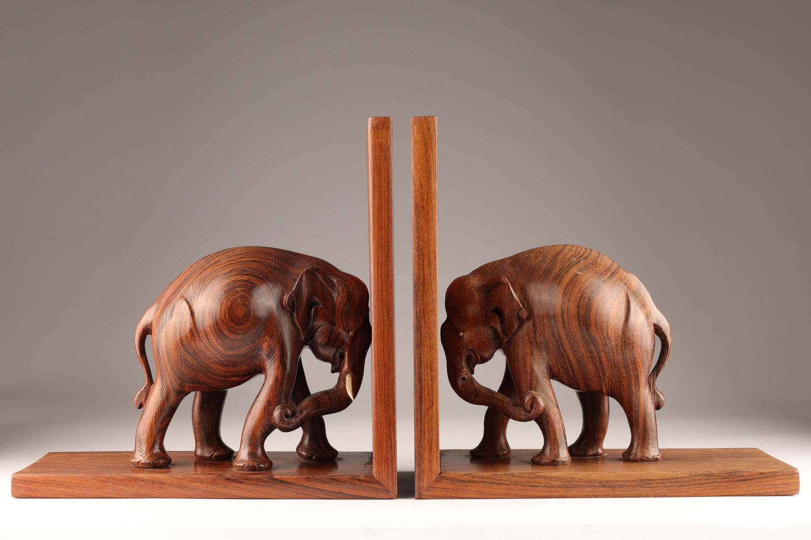Mid Century Rosewood Carved Elephant Bookends: Pair of Large Mid Century Modern Rosewood Carved Elephant Bookends. 13.5 inches H x 13.5 L x 6 deep. Missing one tusk.