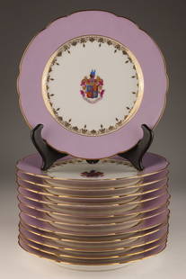 French Porcelain Armorial Lavender Dinner Plates: Set of 12 French white porcelain scalloped edged dinner plates with a wide lavender border, the inner well outlined with gold scroll design and the centre with a coloured armorial bearing / coat of ar