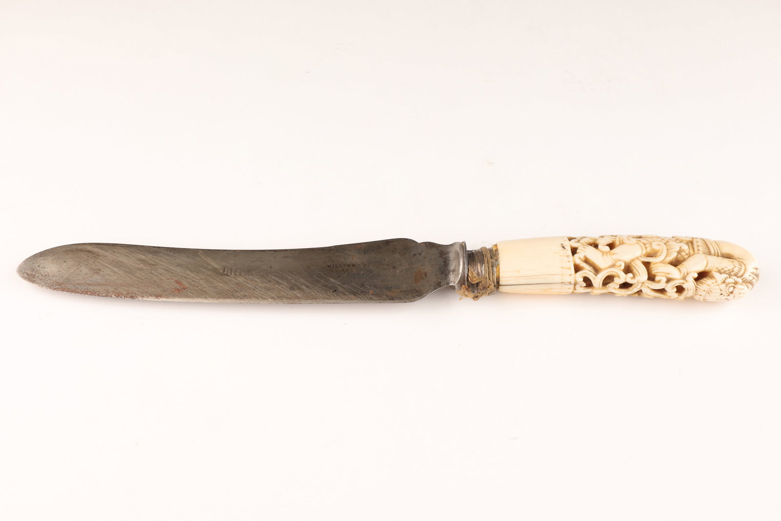 Antique English Knife Burmese Reticulated Handle: Antique English Bread Knife with finely carved Reticulated Burmese Dha Hmyaung Handle. Blade marked William S. Burton 39 Oxford. Handle carved to depict a god bent over backwards. This item cannot be 