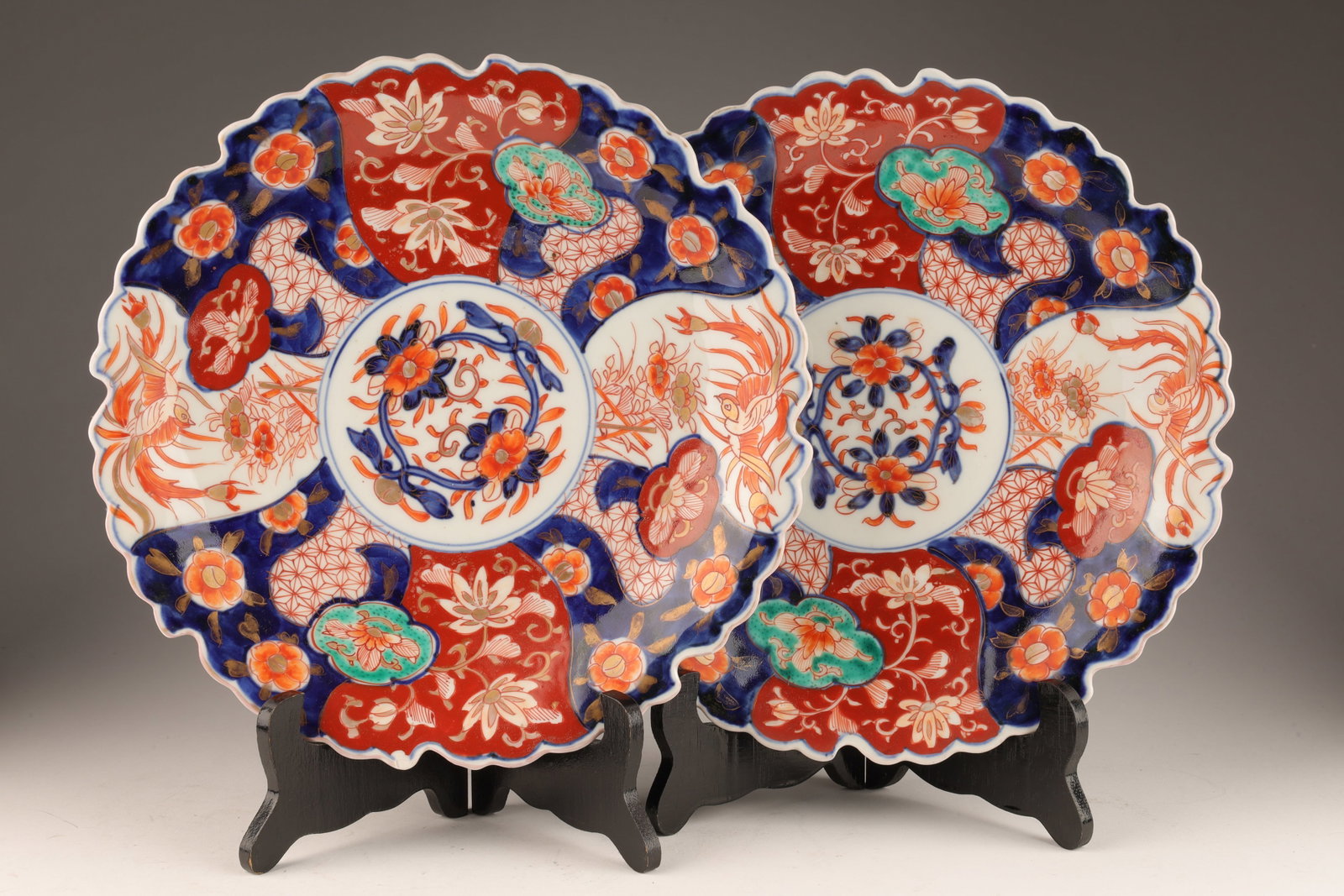 Pair of Antique Japanese Imari Scalloped Plates: Pair of Antique Japanese Imari Scalloped Plates. In traditional Imari colours, decorated flowers and birds with irregular scalloped rims. One small chip. 11 inches diameter.