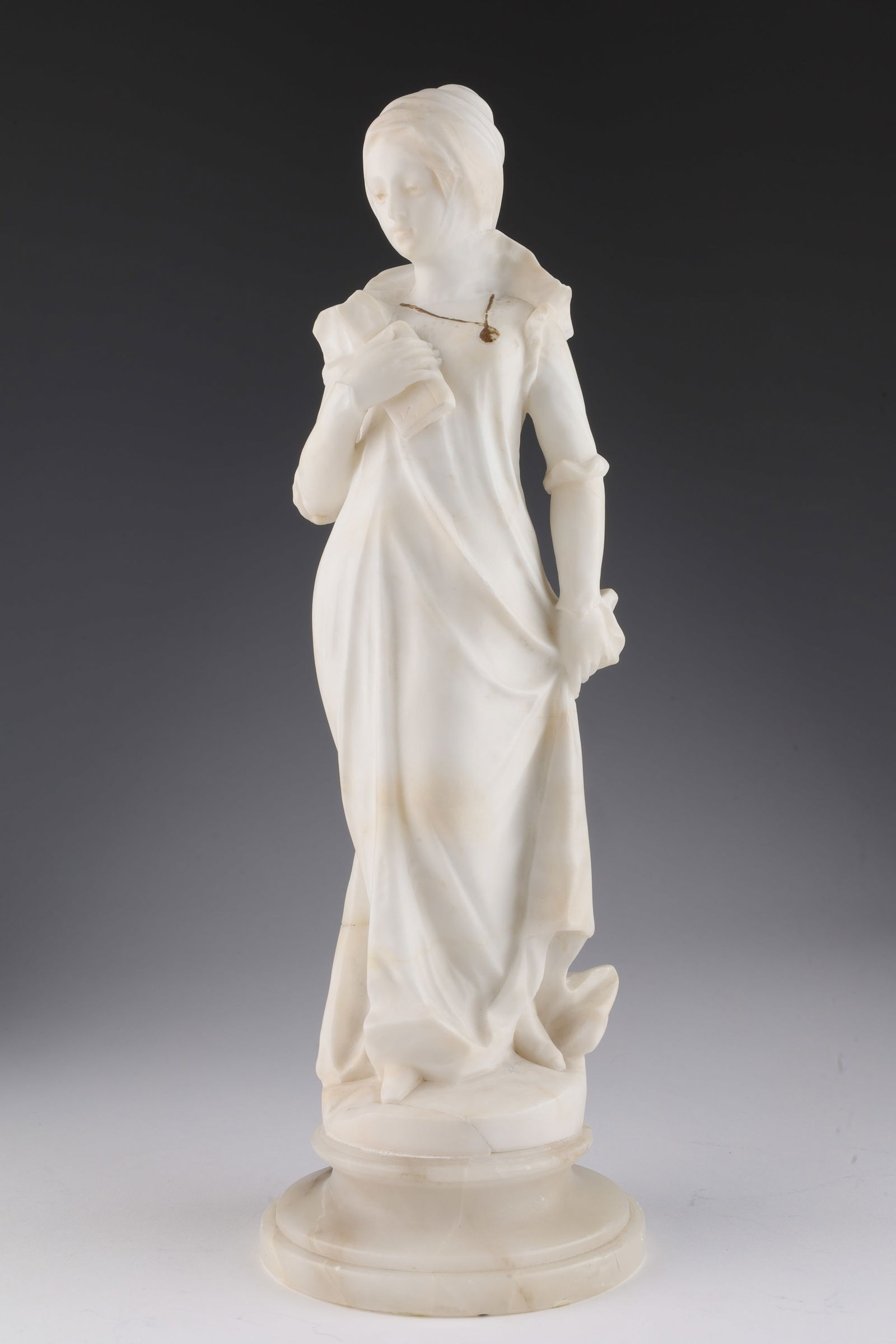 Antique French Alabaster Sculpture of a Woman Nun: Antique French Alabaster Sculpture of a Woman Wearing a Wimple / Nun with a gold painted locket. 14.5 inches H.