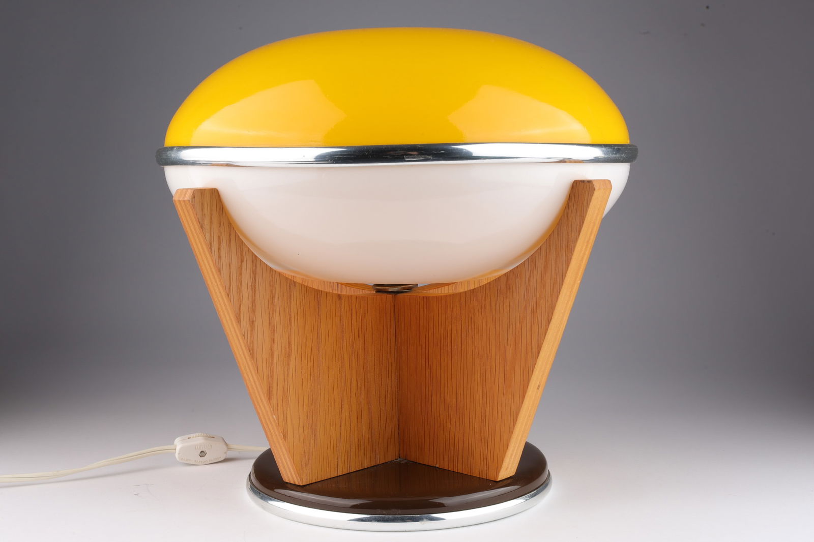 Mid Century Modern / Atomic / Space Age Table Lamp: Mid Century Modern / Atomic / Space Age Table Lamp with Yellow and White Plastic and Chrome shade on Wood Lamp base.. 11 inches H x 12 W