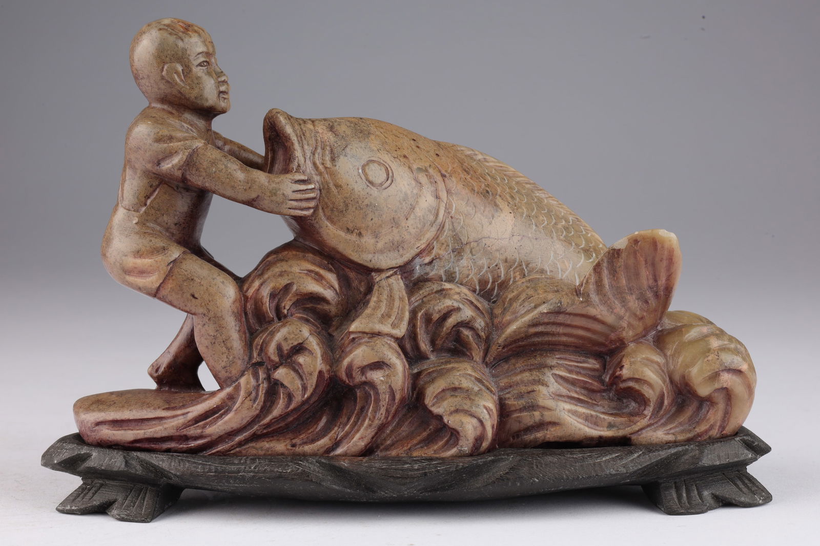 Chinese Carved Soapstone Boy with Fish: Chinese Carved Soapstone Boy with Fish on Wood Base Marked. 6.5 inches L x 4.5 H x 2.5 deep.