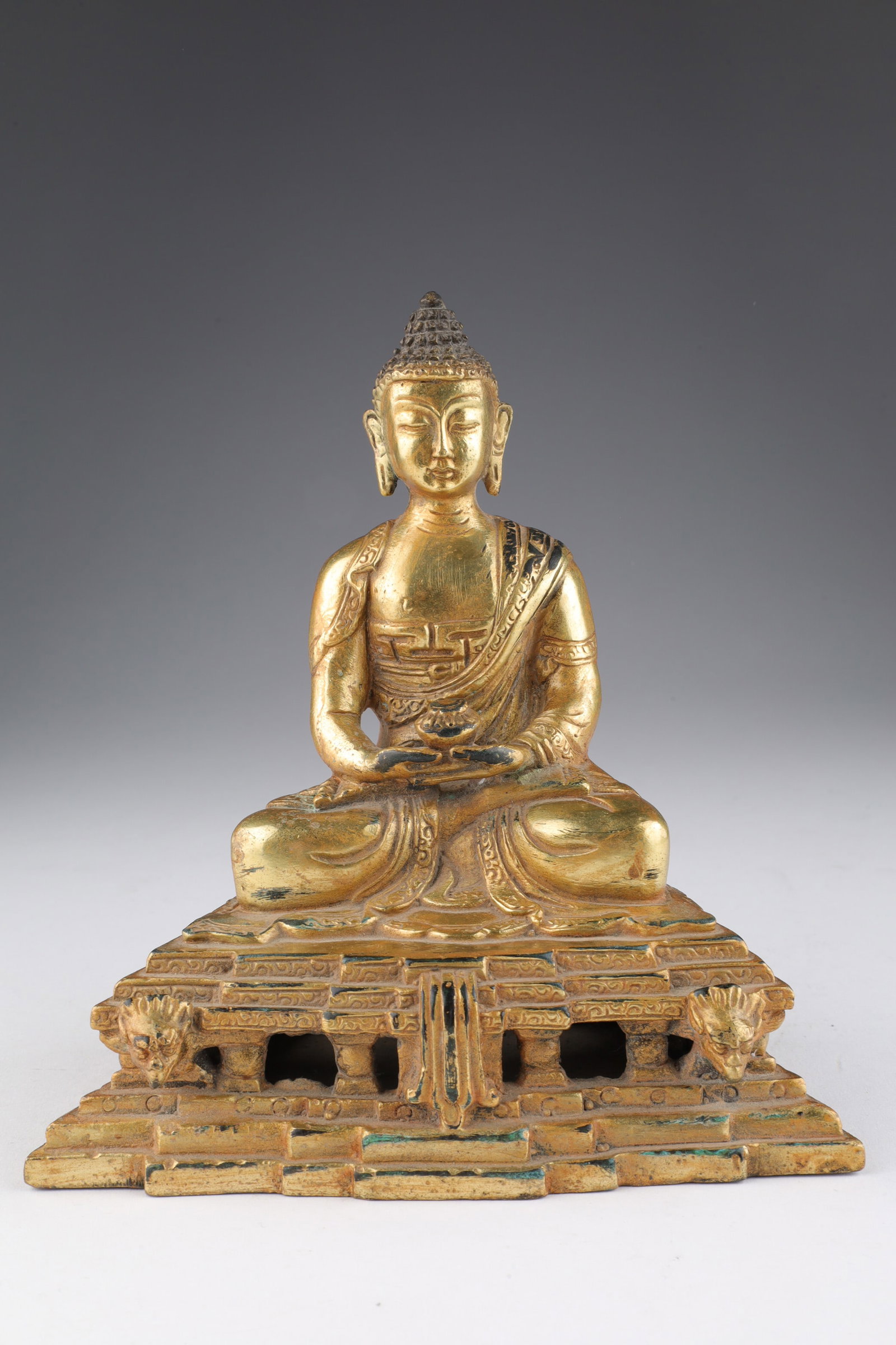 Tibetan Gilt Seated Shakyamuni Buddha Marked: Tibetan Gilt Shakyamuni or Amitabha Buddha Marked. Seated in lotus posture on a two-tier lotus base and holding a censer. 6 inches H x 4.75 W x 2.75 deep.