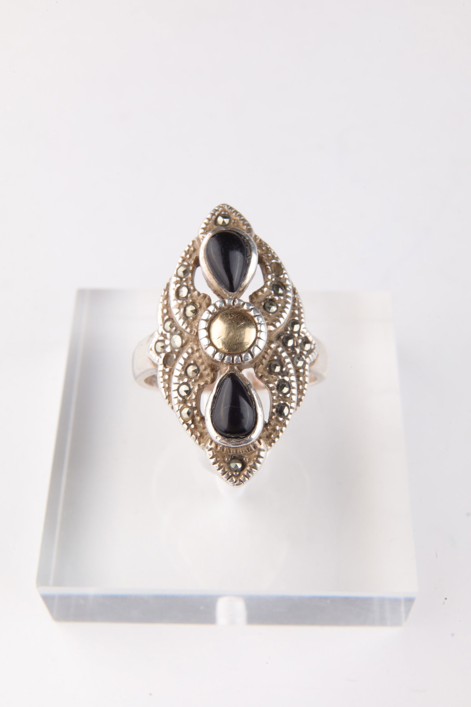 Art Deco 18K Sterling Marcasite Onyx Ring Size 7: Art Deco 18K Gold and Sterling Ring with Onyx and Marcasite Stones. Size 7. Face measures 1 inch x 0.5 inches W. Total weight 5.9 grams.