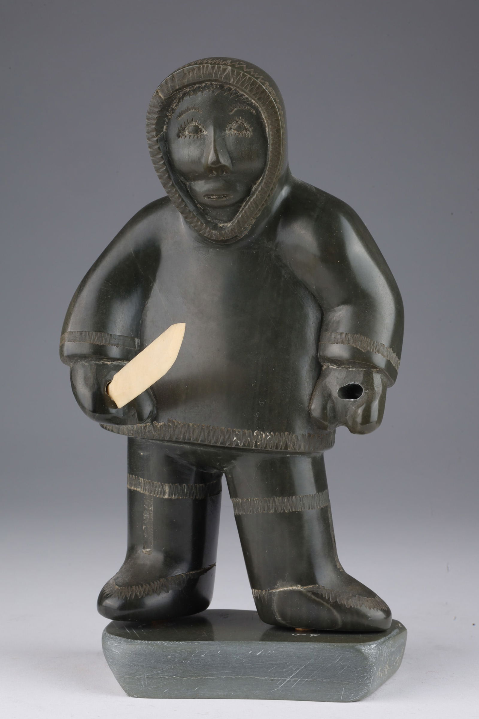 Signed Charlie Tooktoo Inuit Hunter Soapstone: Signed Charlie Tooktoo Inuit Hunter Soapstone Carving. 8 inches H x 4 W x 3 deep including separate base. Signed on base.