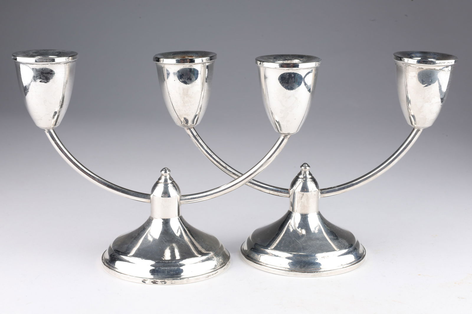 Pair Sterling Silver Duchin Two Arm Candlesticks: Pair Sterling Silver Weighted Duchin Creation Two Arm Candlesticks. 7.5 inches W x 5.5 H x 3.25 W.