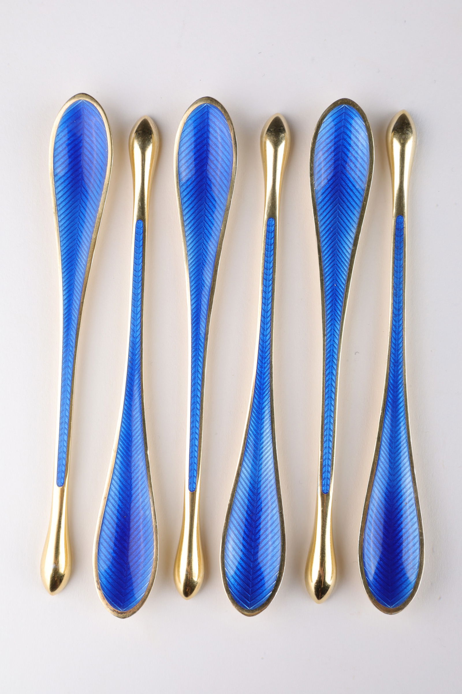 Danish E Lauridsen Sterling Enamel Marrow Scoops: Rare set of 6 heavily gilded sterling silver individual marrow scoops, one side with deep cobalt blue guilloche enameling with feather design, marked on each Ela Denmark Sterling 925S. 4 inches L