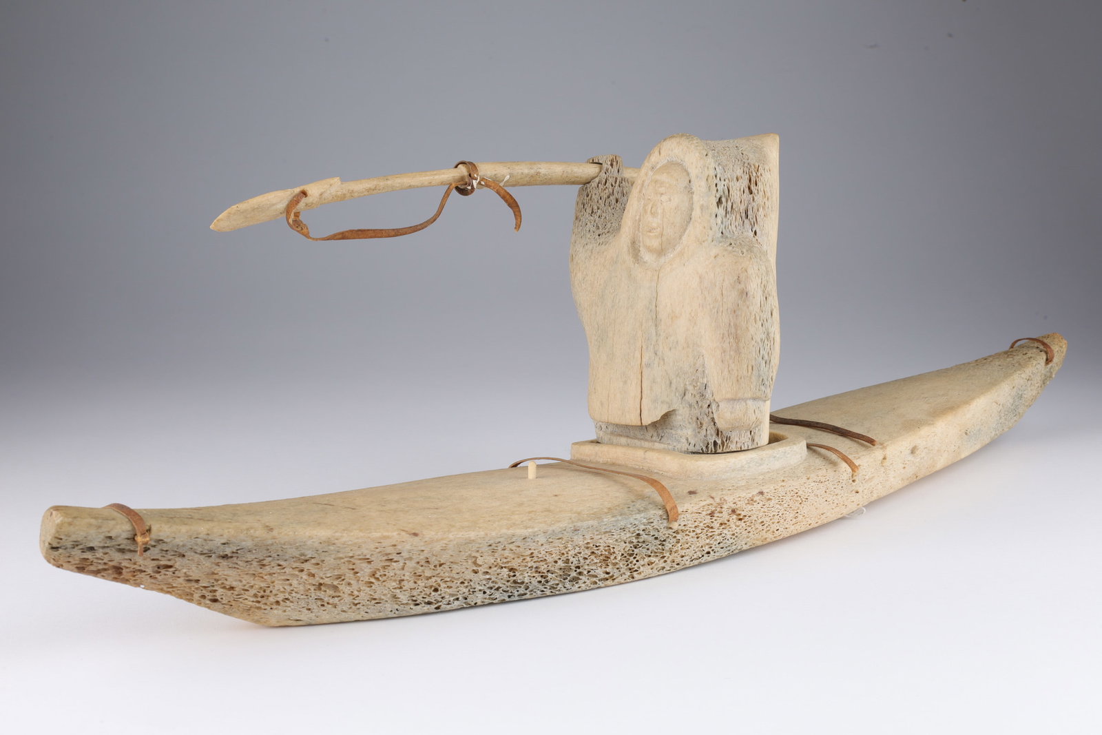 Large Inuit Eskimo Carved Bone Hunter in Kayak: Large Inuit Eskimo Carved Bone Hunter in Kayak with Harpoon. This item cannot be exported from Canada. Kayak measures 20 inches L x 4 W, 7 inches H with hunter.