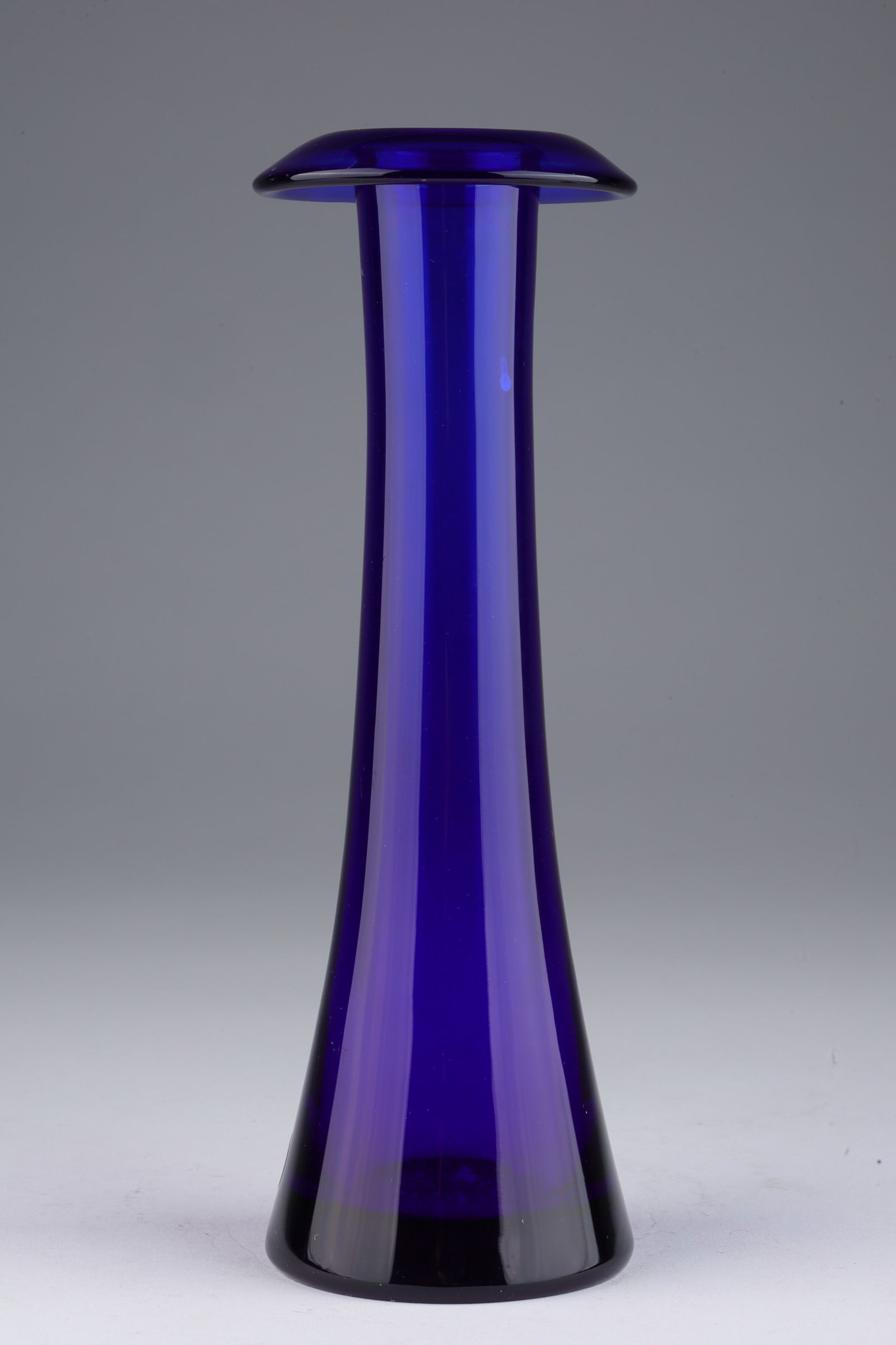 Tiffany Elsa Peretti Seguso Cobalt Art Glass Vase: Italian art glass vase designed by Elsa Peretti (1940 - 2021) for Tiffany and Company, of cobalt blue glass and circular form with turnover upper rim, manufactured by Archimede Seguso of Murano Italy,
