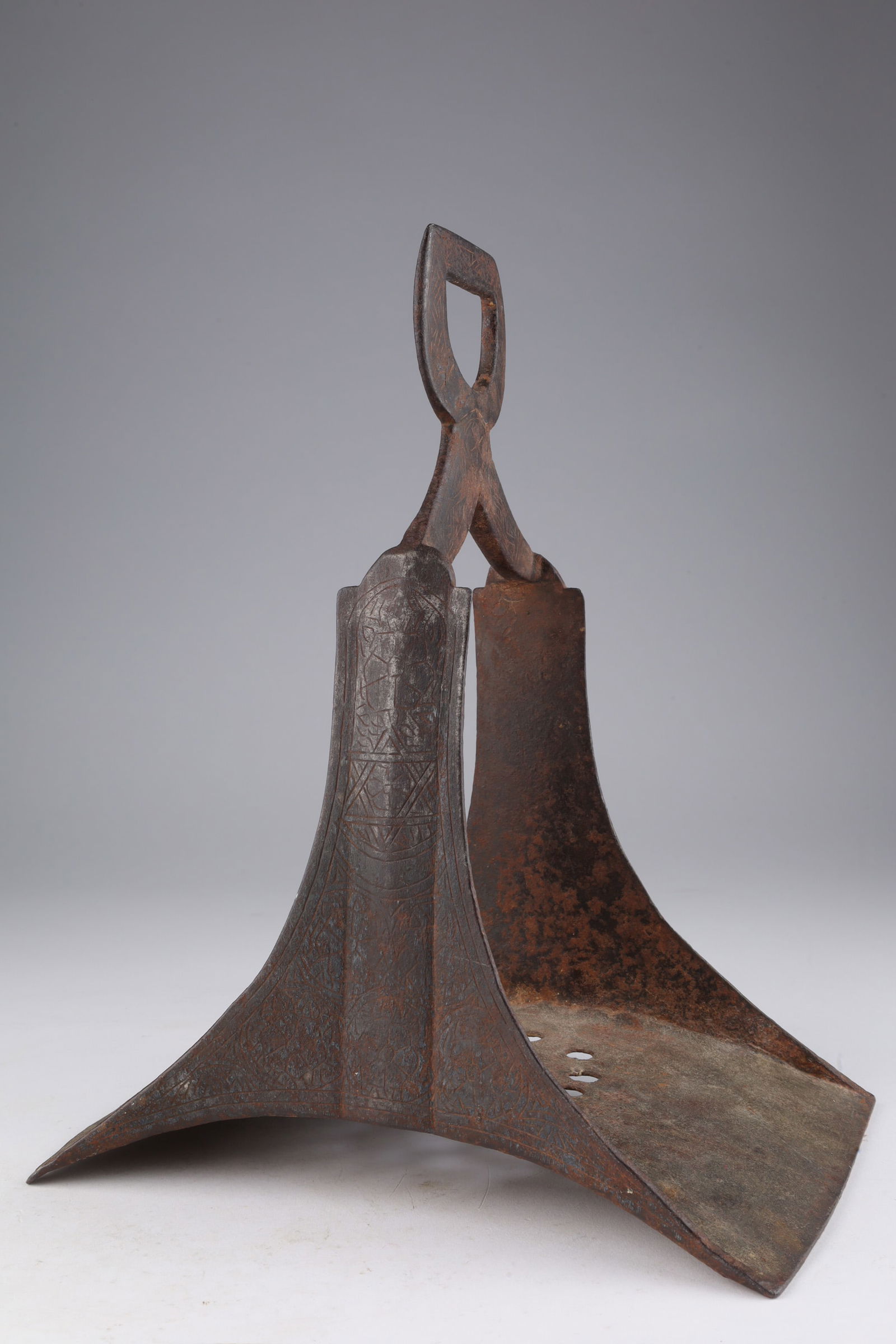Antique Middle Eastern Iron Stirrup: Antique Middle Eastern Iron Stirrup with engraved decoration. 8 inches W x 6 deep x 10 H.
