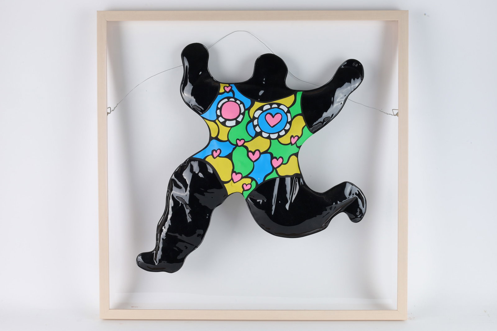 Niki de Saint Phalle Pop Art Nana Blow Up Doll: Niki de Saint Phalle (France, 1930 - 2002) pop art plastic blow up doll entitled Nana, created in 1992, fully signed on back, set in natural wood frame on acrylic back, figure is adhered to acrylic ba