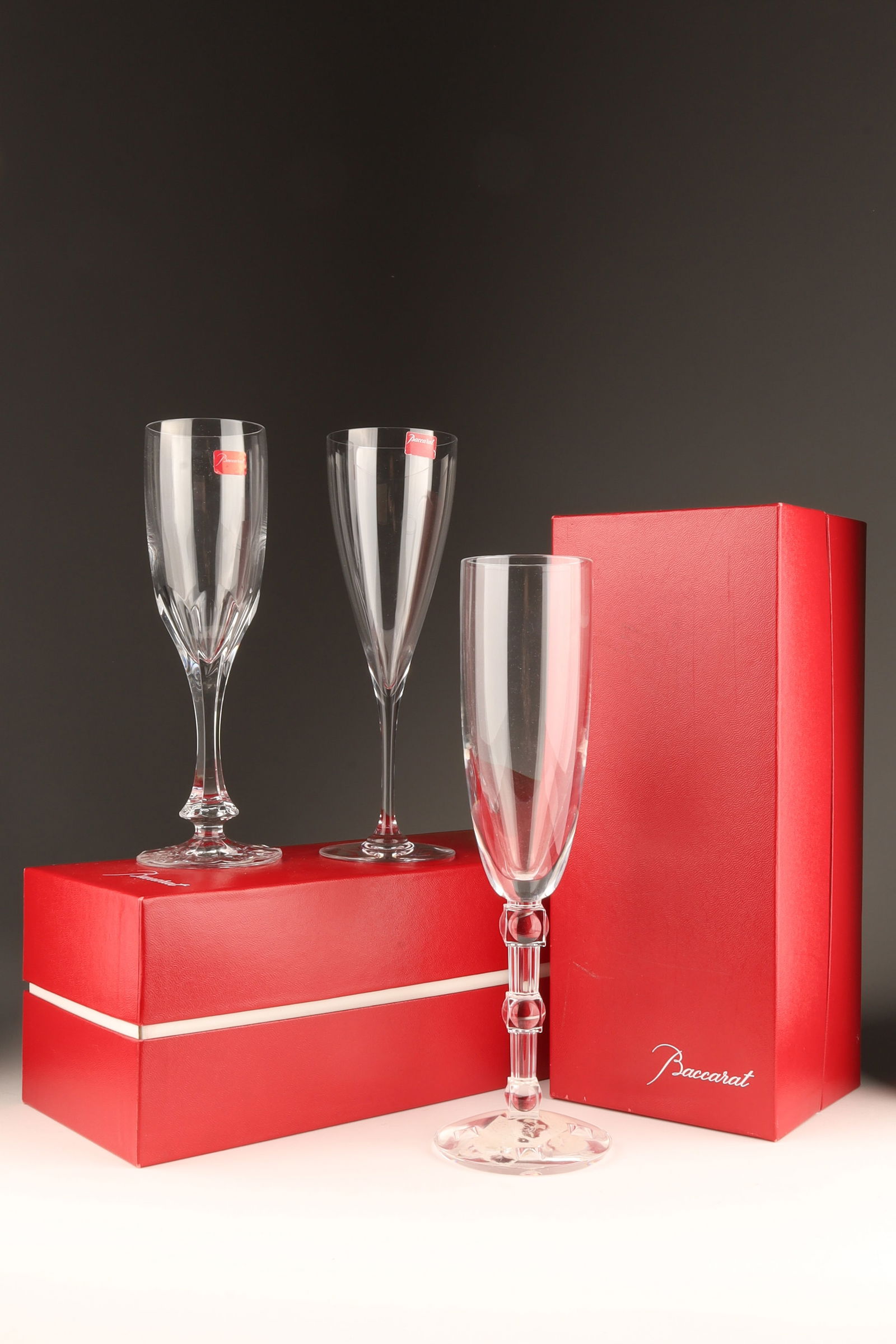 Group of Baccarat Crystal Champagne Flutes: Group of 3 Baccarat Crystal Champagne Flutes. Claire de Lune (10 inches H), Neptune (8 inches H) and Dom Perignon (8 inches H). Two in boxes, (boxes measure 11 inches L x 4.5 x 4.5).