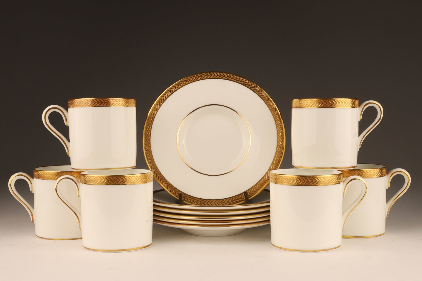Wedgwood Gold Rim Senator Demitasse Cups Saucers: Set of 6 Wedgwood Bone China Gold Laurel Rim Senator Pattern Demitasse Cups and Saucers. One cup has small spot of loss on rim. Cups measure 2.25 inches H, saucers measure 5 inches diameter.