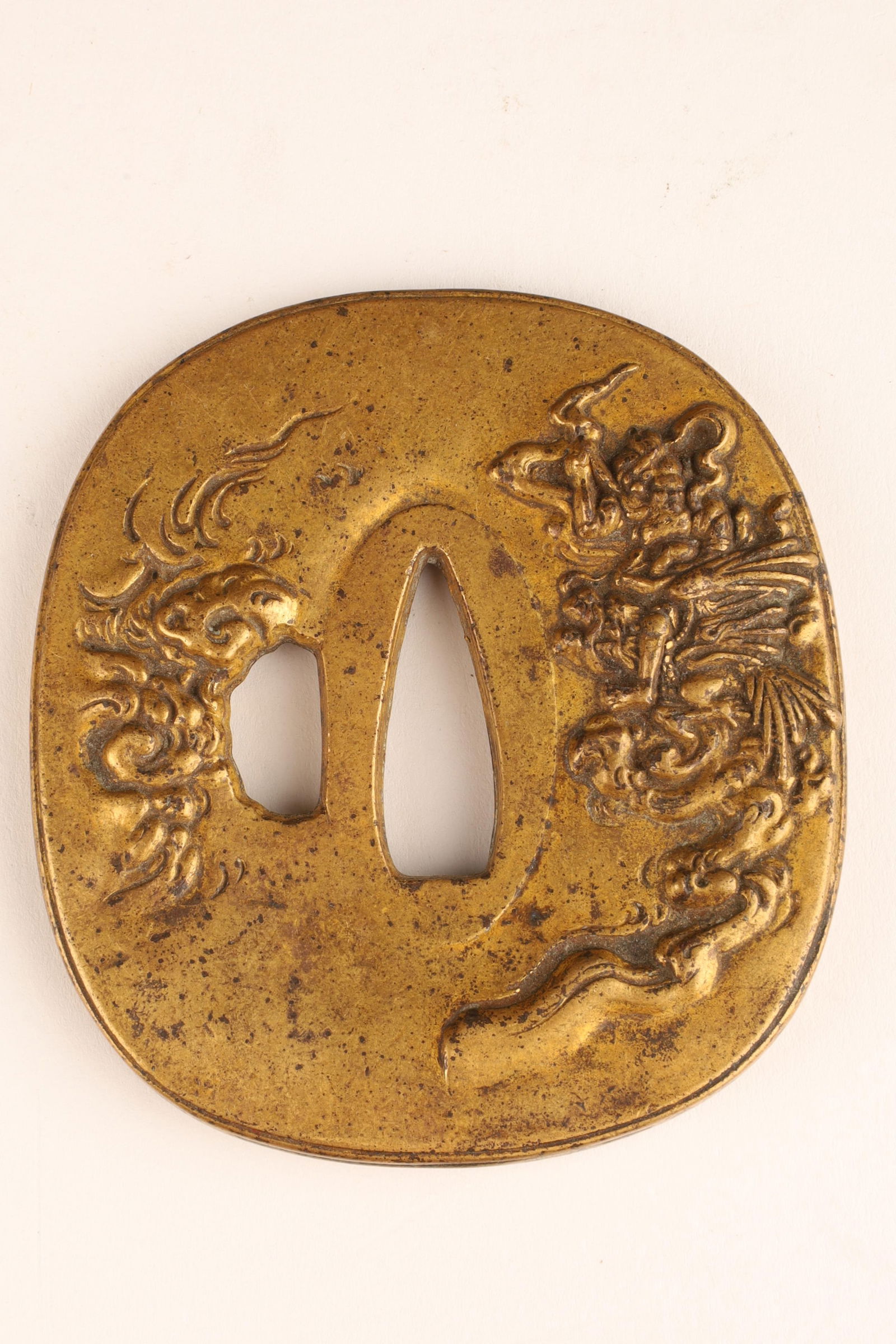 Signed Japanese Brass Sword Guard Tsuba: Signed Japanese Brass Sword Guard Tsuba decorated with waves on one side. 3 inches H x 2.75 W.