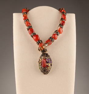 C and D New York Red Snake Necklace Iradj Moini: C and D New York Carnelian Snake Necklace in the Style of Iradj Moini. Set with Smokey Topaz / Quartz and rhinestones. 24 inches L. Snake head is loose, some repairs to welds. Missing one stone.