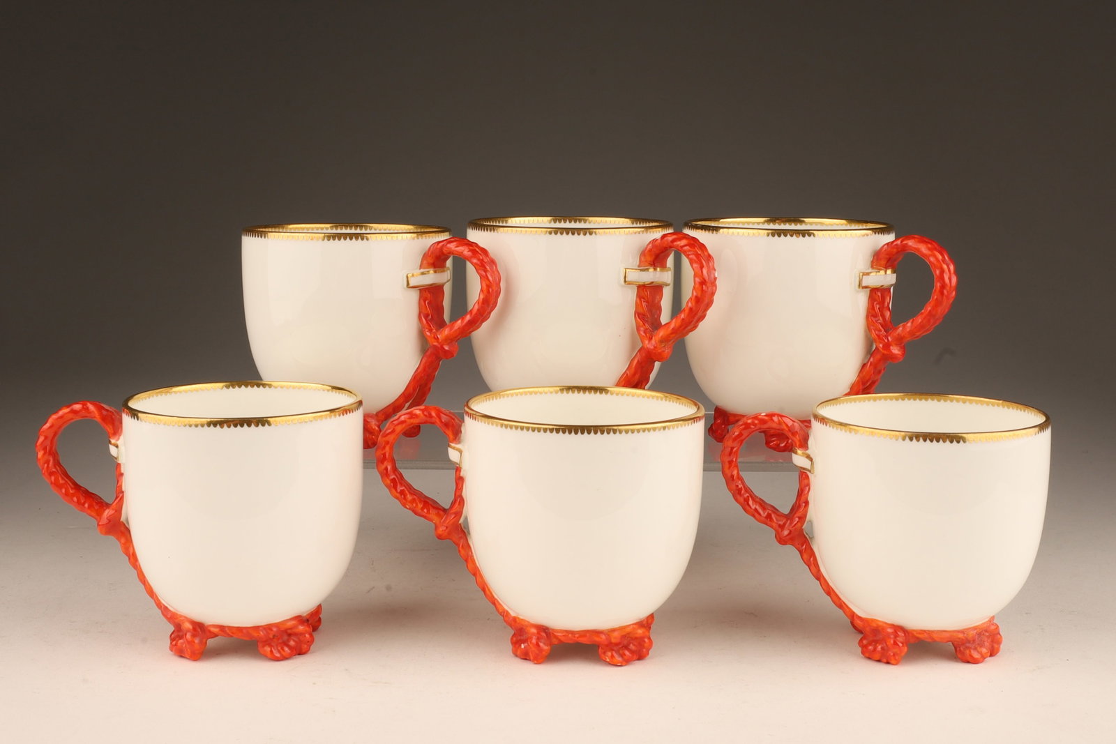 English Porcelain Coffee Cups Twisted Rope Handles: Set of Six English Porcelain Demi-Tasse Coffee Cups with Red Twisted Rope Handles marked with British Kite Mark. 2.5 inches H x 3.25 W.