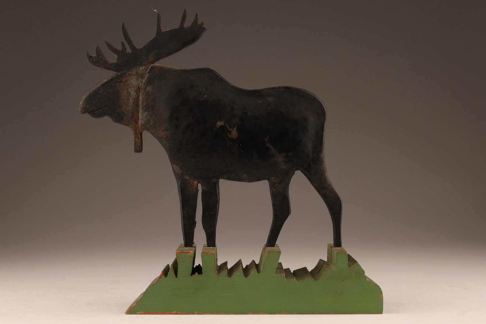 Canadian Folk Art Forged Iron Moose Sculpture: Canadian Folk Art Forged Iron Moose Sculpture Mounted on wood cut green grass base. 6 inches H x 6 L x 2 W.