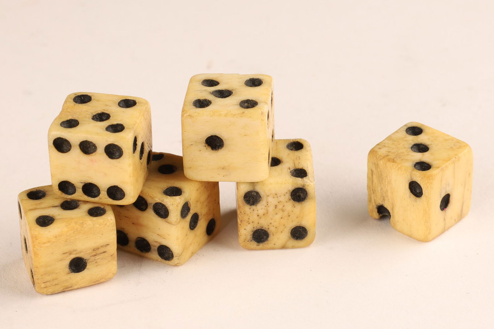 Set of 6 Antique Carved Bone Six Sided Dice: Set of 6 Antique Carved Bone Six Sided Dice. All approximately 0.5 inches cubed.