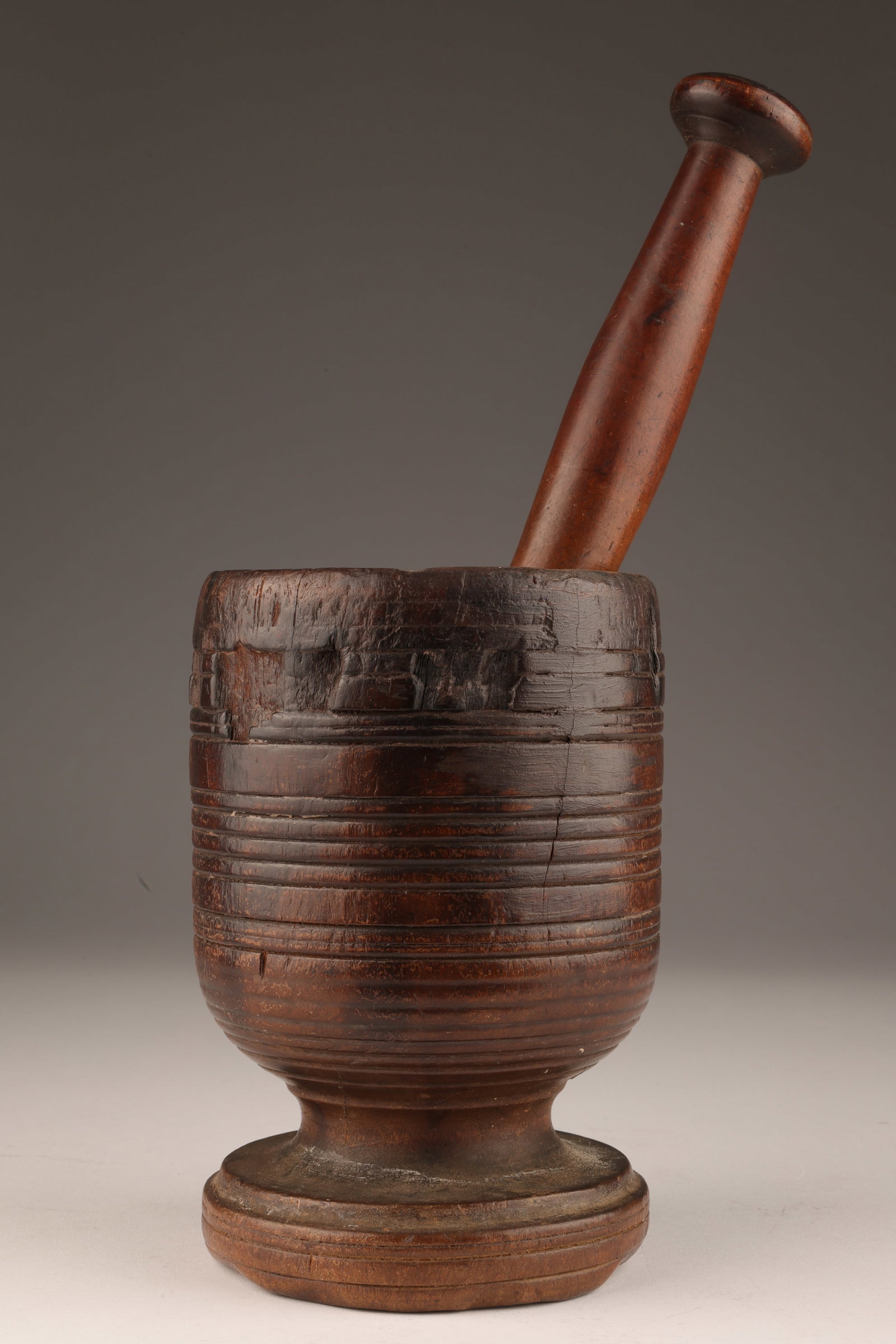 Antique Primitive Turned Wood Mortar and Pestle: Antique Primitive Turned Wood Mortar and Pestle. Mortar measures 6.5 x 4 inches W, pestle measures 9 inches L.