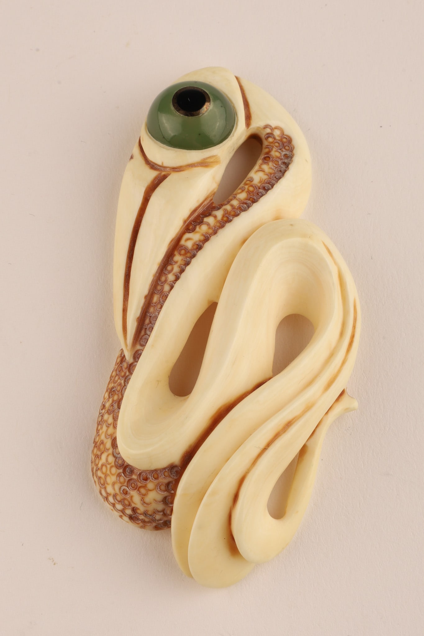 Maori Carved Pendant Sculpture of a Manaia: Signed New Zealand, Maori Carved Pendant Sculpture of a Manaia with the head of a bird and the tail of a fish, inlaid stone Eye. Signed NH. 3.25 inches L.