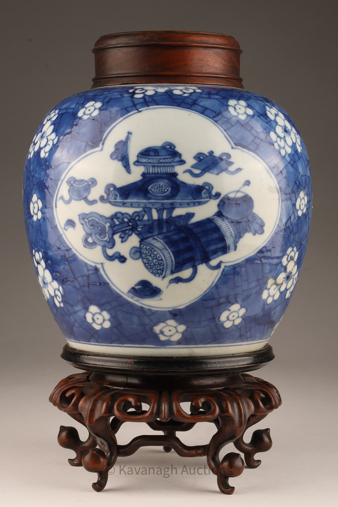 Antique Chinese Blue and White Ginger Jar: Chinese antique ovoid shaped ginger jar decorated in blue underglaze, with ogee-shaped cartouche showing auspicious symbols / precious objects on a cracked ice ground with cherry blossoms, with lid an