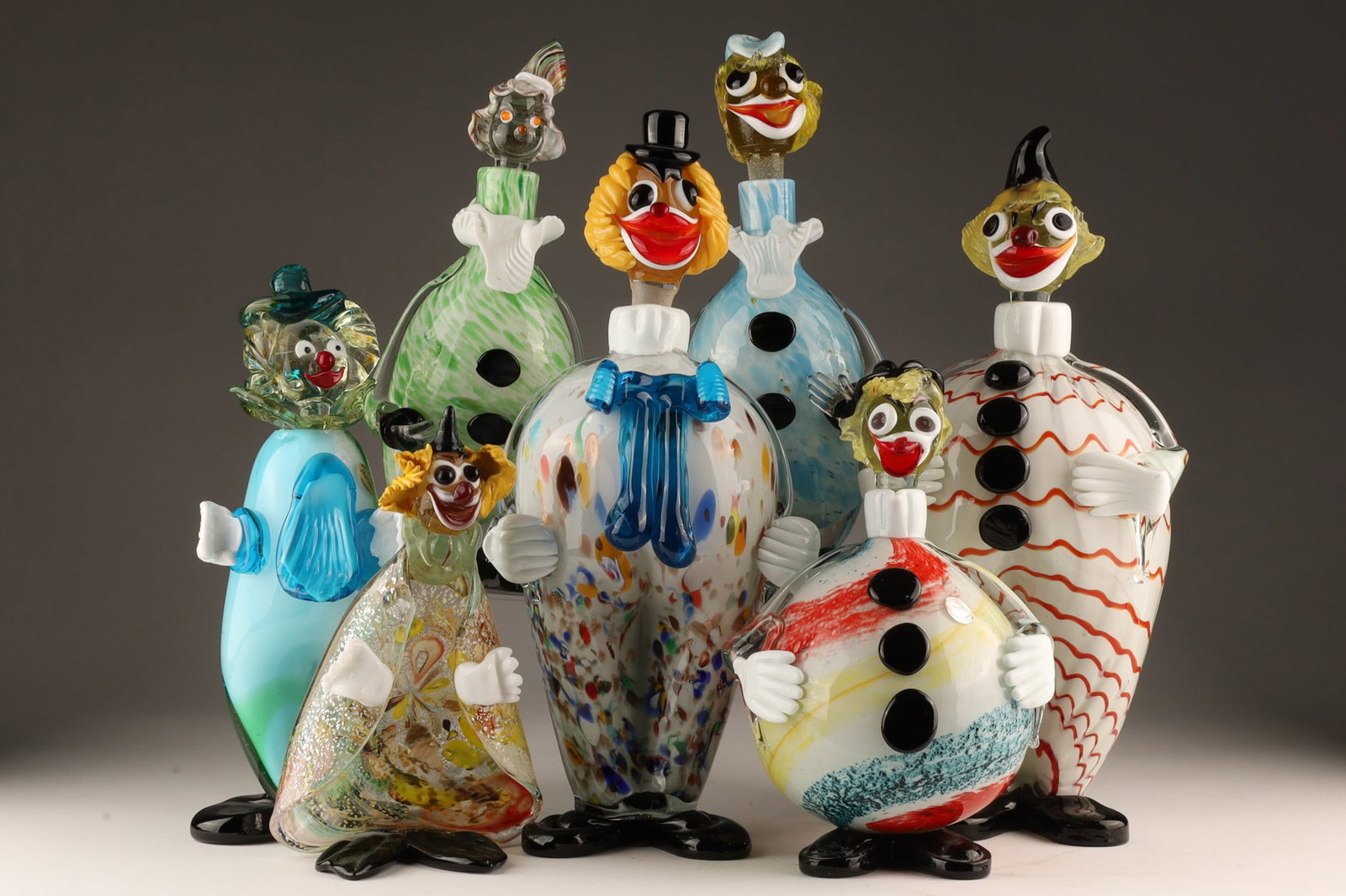 Collection MCM Murano Clown Decanters Figures: Collection of 7 Mid Century Modern Murano Blown Glass Clown Decanters Figures. 5 decanters and 2 figures. Some with chips. Between 8 inches and 14 inches H.