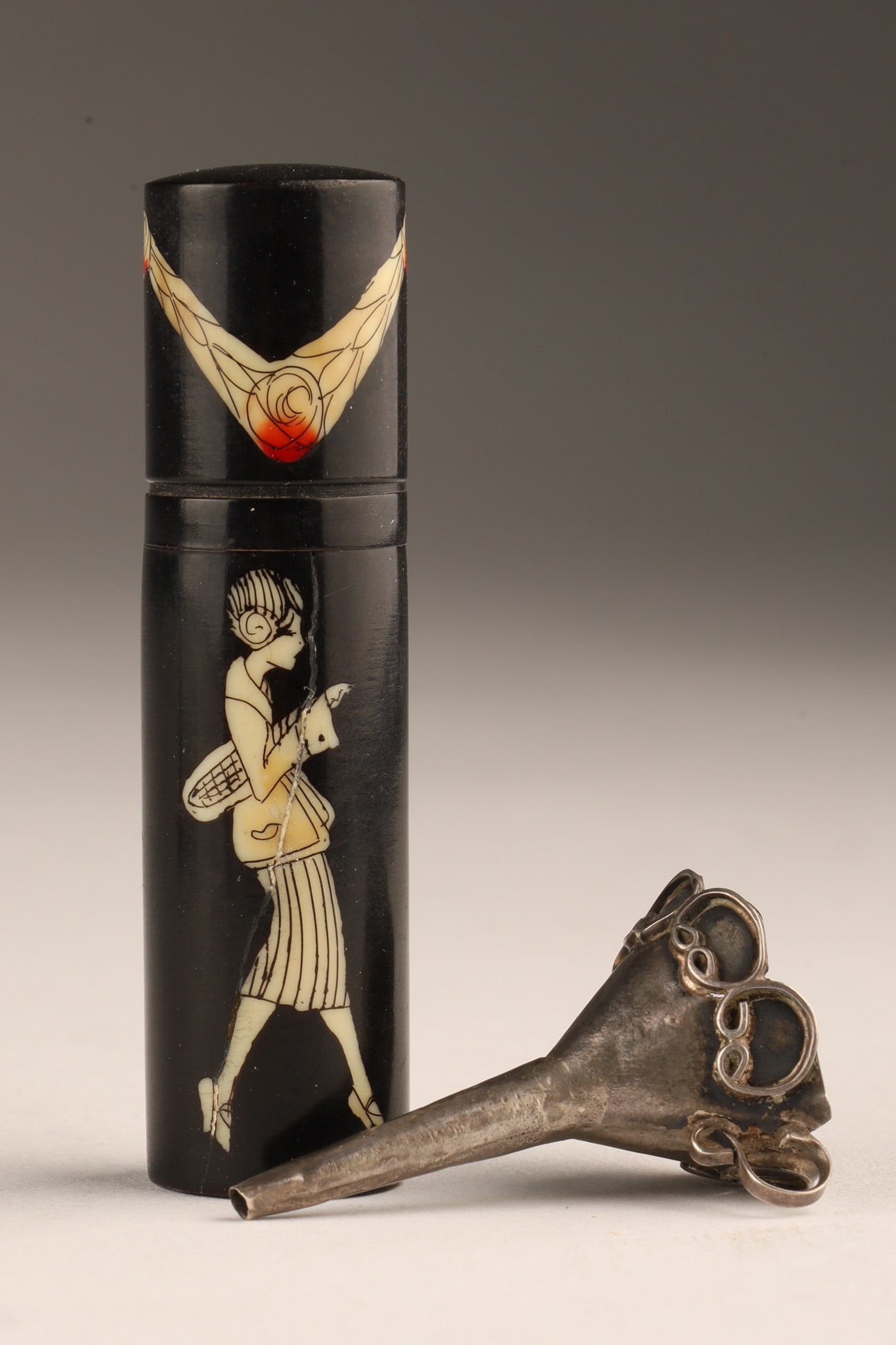 Art Deco French Celluloid Perfume Bottle Funnel: Art Deco French Celluloid Small Perfume Bottle with Sterling Funnel. Bottle decorated with a figure of a flapper woman, top decorated with rose garlands. Measures 2.25 inches H, funnel measures 1.5 in
