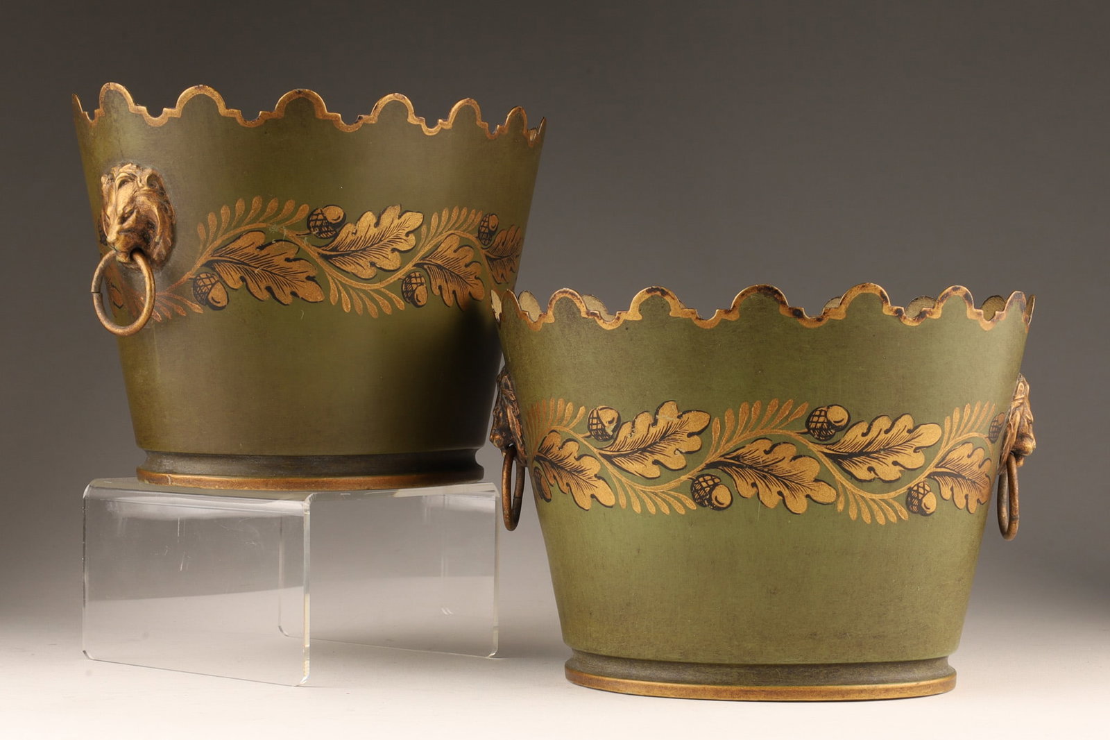 Pair of French Tole Ware Green Gold Jardinieres: Pair of French tole ware jardinieres. Gilt decoration with leaves and acorns. Both with lion head handles. Marked on bottom Made in France. 5 inches H x 7 W x 5.5 deep.