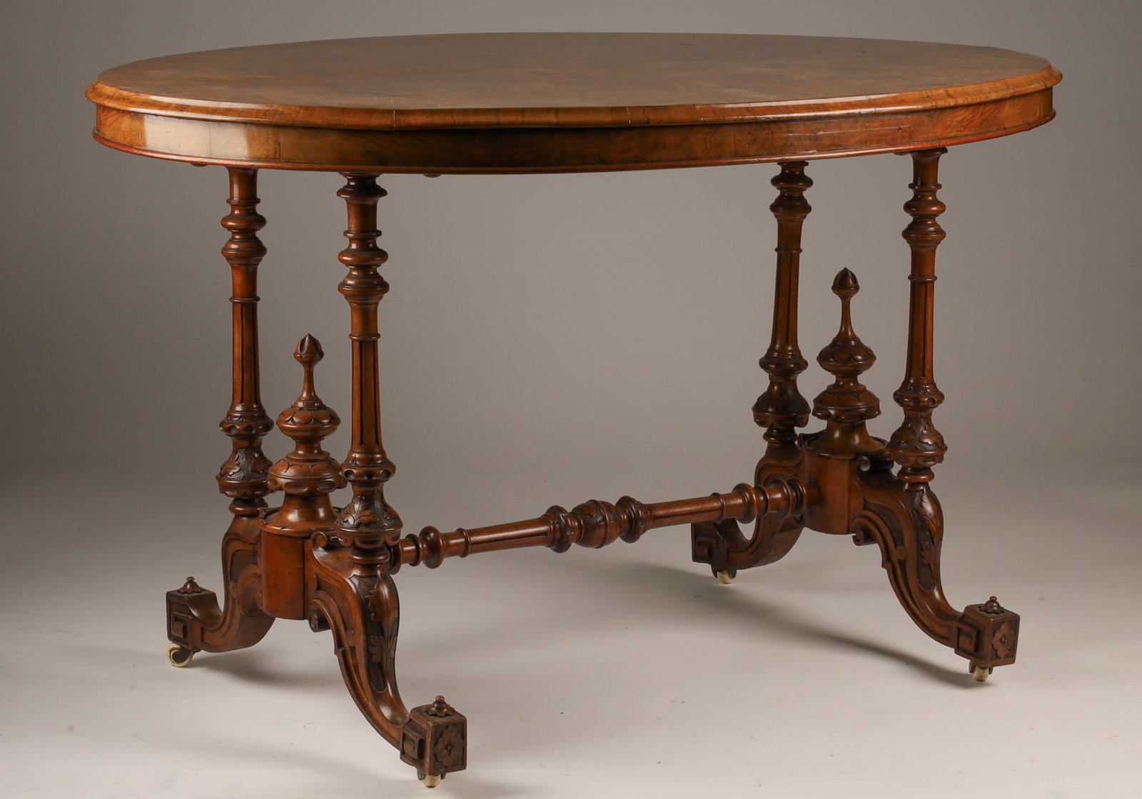 Victorian Antique Oval Burr Walnut Centre Table: Victorian Antique Oval Burr Walnut Inlaid Centre Table with Turned Column Legs and Shaped Stretcher. 29 inches H x 48 L x 34 deep.