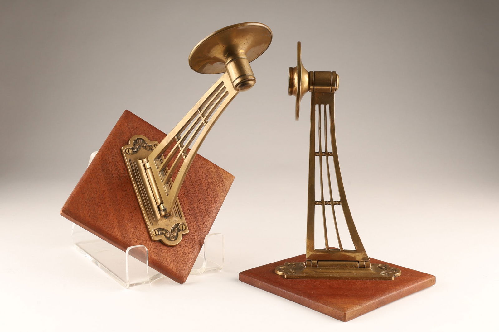 Antique Austrian Secessionist Candle Piano Sconces: Austrian Secessionist wall-mount swing-arm Candle Scones circa 1900 cast brass or bronze with added mahogany mounting. Sconces measure 11 inches deep x 8 W x 8 H including plaques.