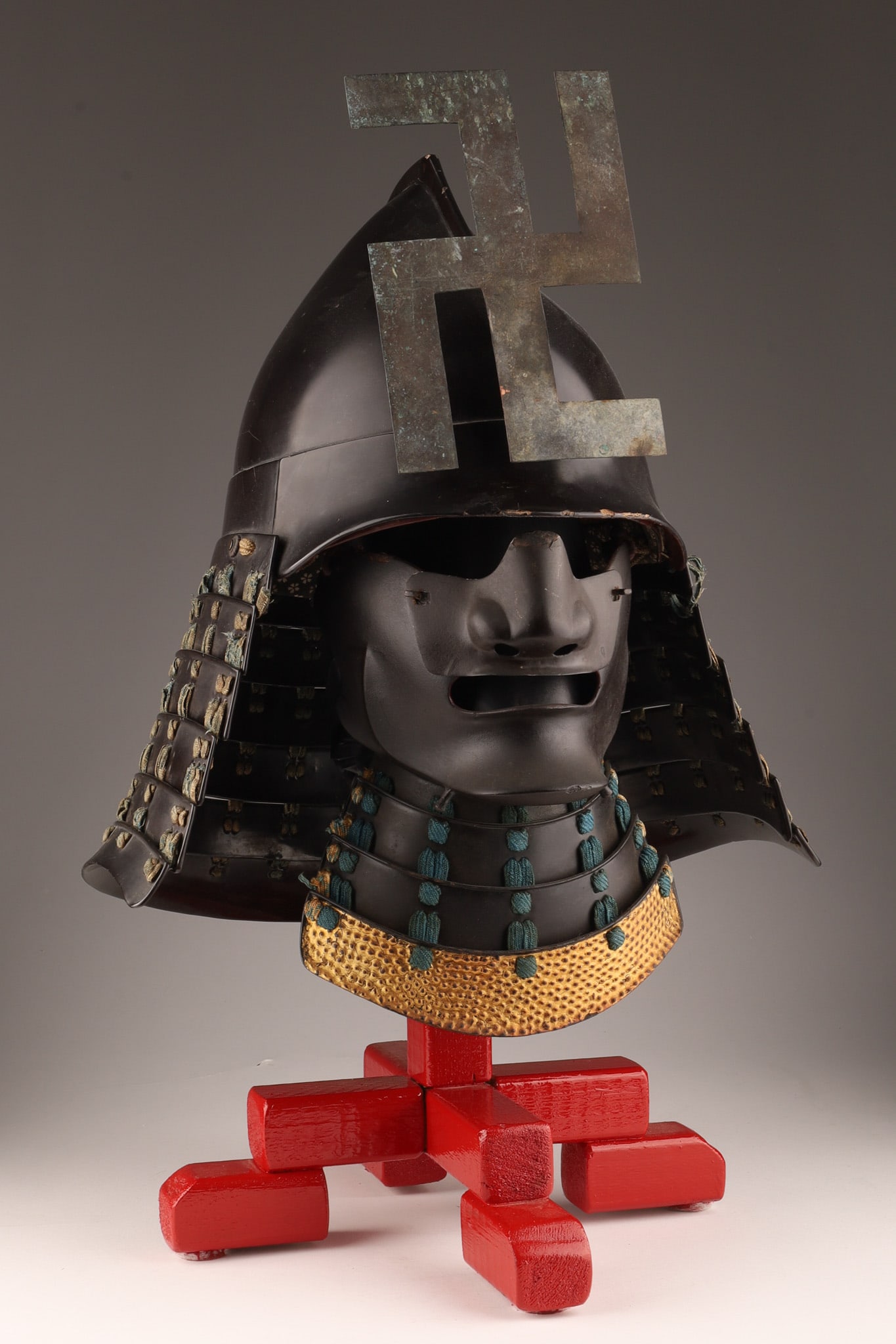 Antique Japanese Samurai Kabuto and Menpo: Antique Samurai kabuto called Momonari, with a menpo, the helmet is decorated with a very special maedate called Swastika. The swastika was a symbol of prosperity, good fortune and peace and in use in